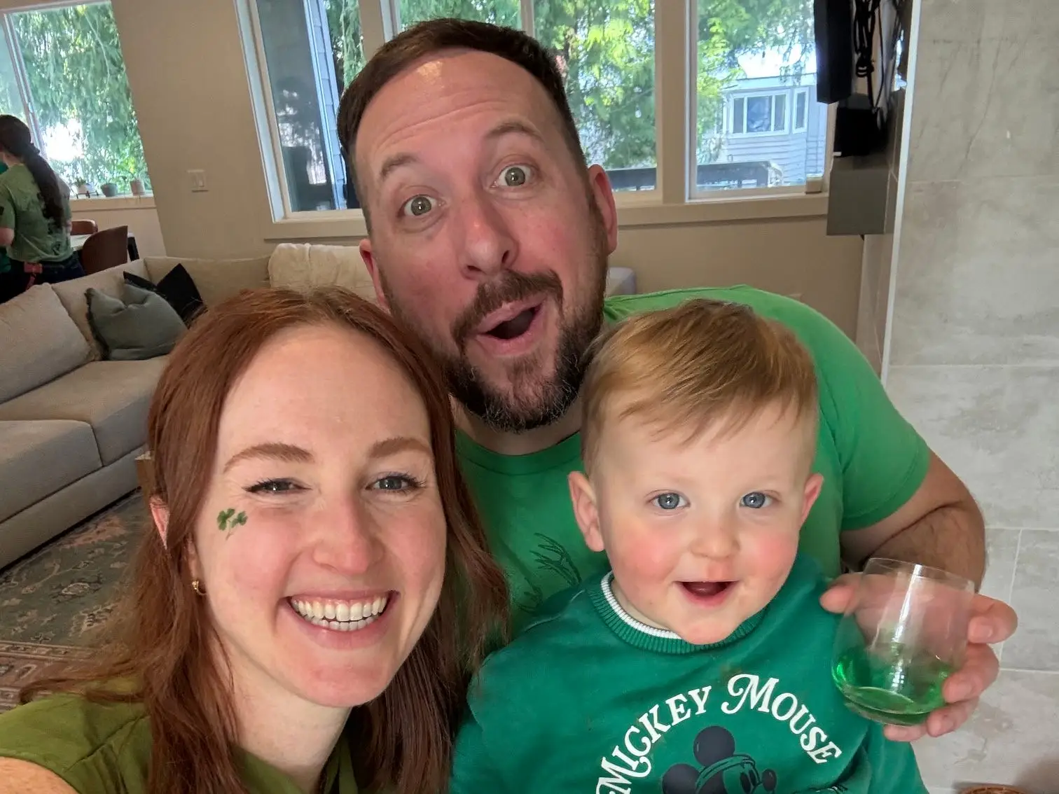 Elianor Williamson smiles at the camera with her husband and son