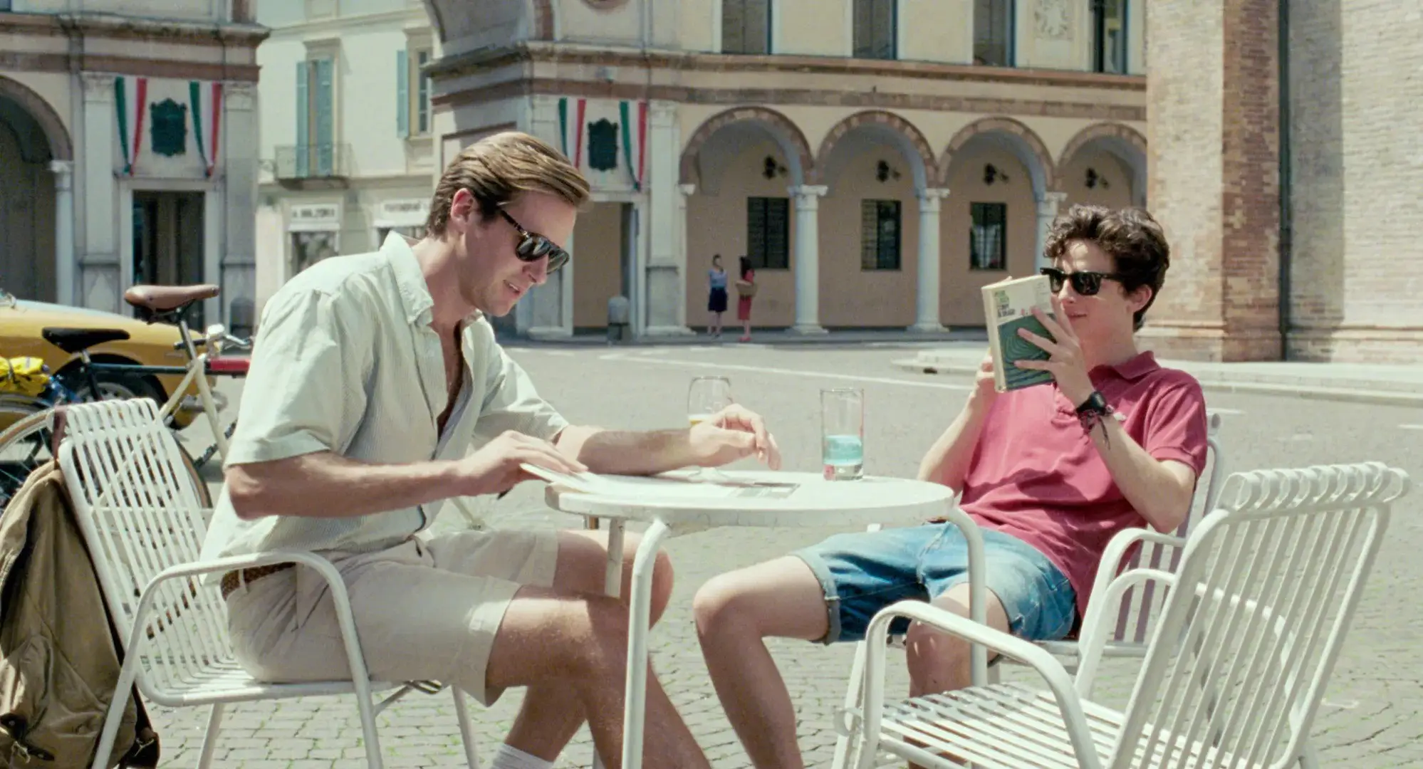 Armie Hammer and Timothée Chalamet at a table in Call Me by Your Name movie