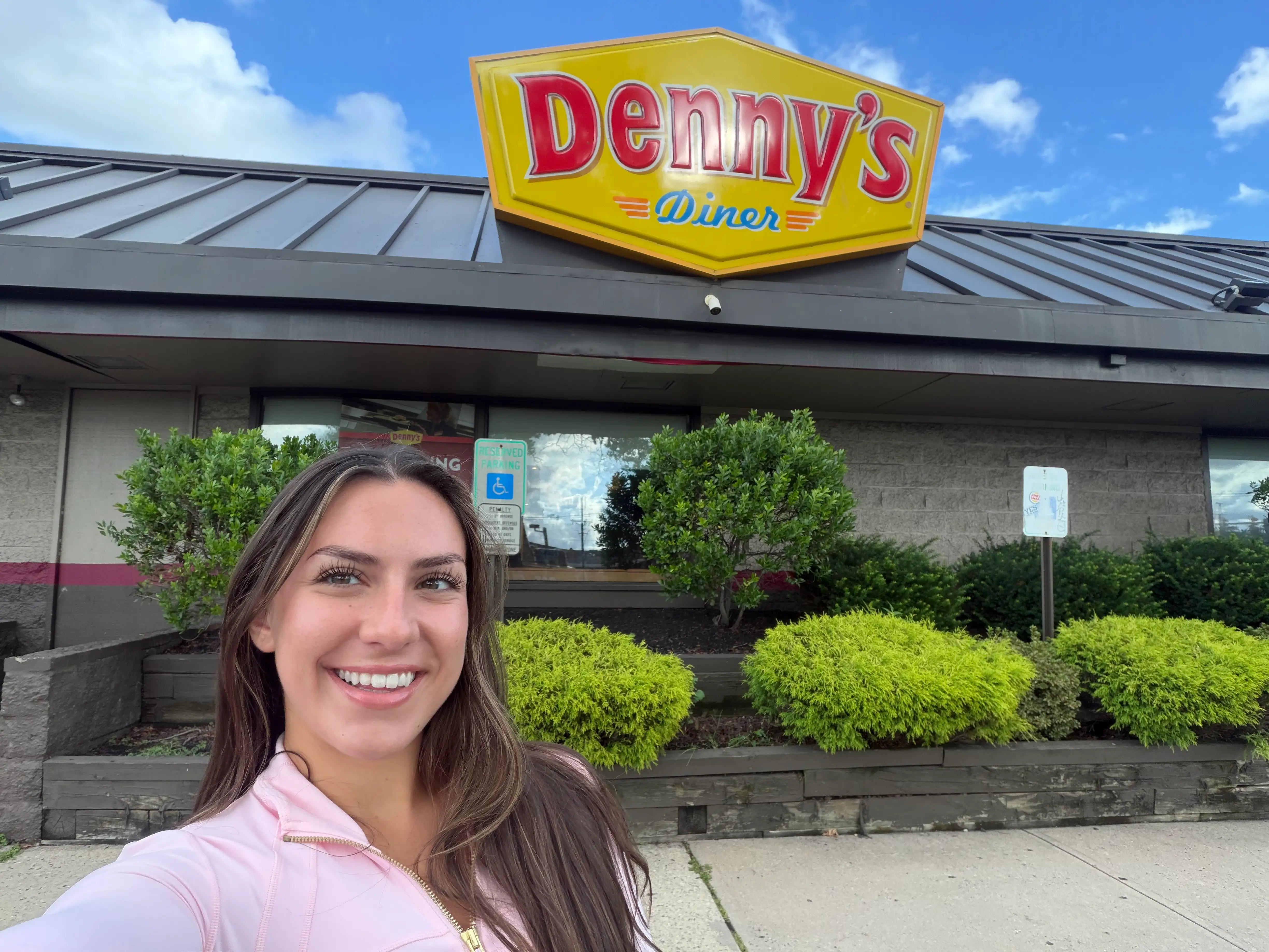 Amanda takes a selfie outside Denny's.