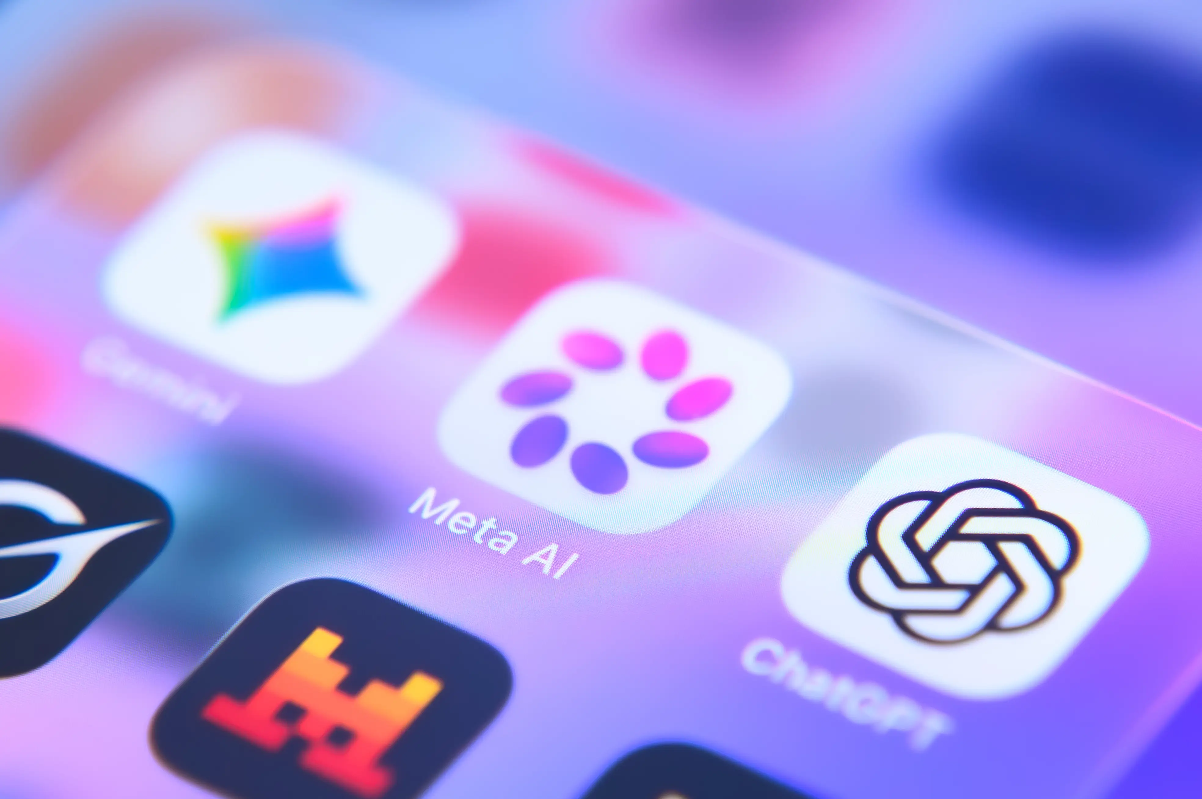 An AI application folder containing Meta AI, Gemini, and ChatGPT is displayed on a smartphone screen.