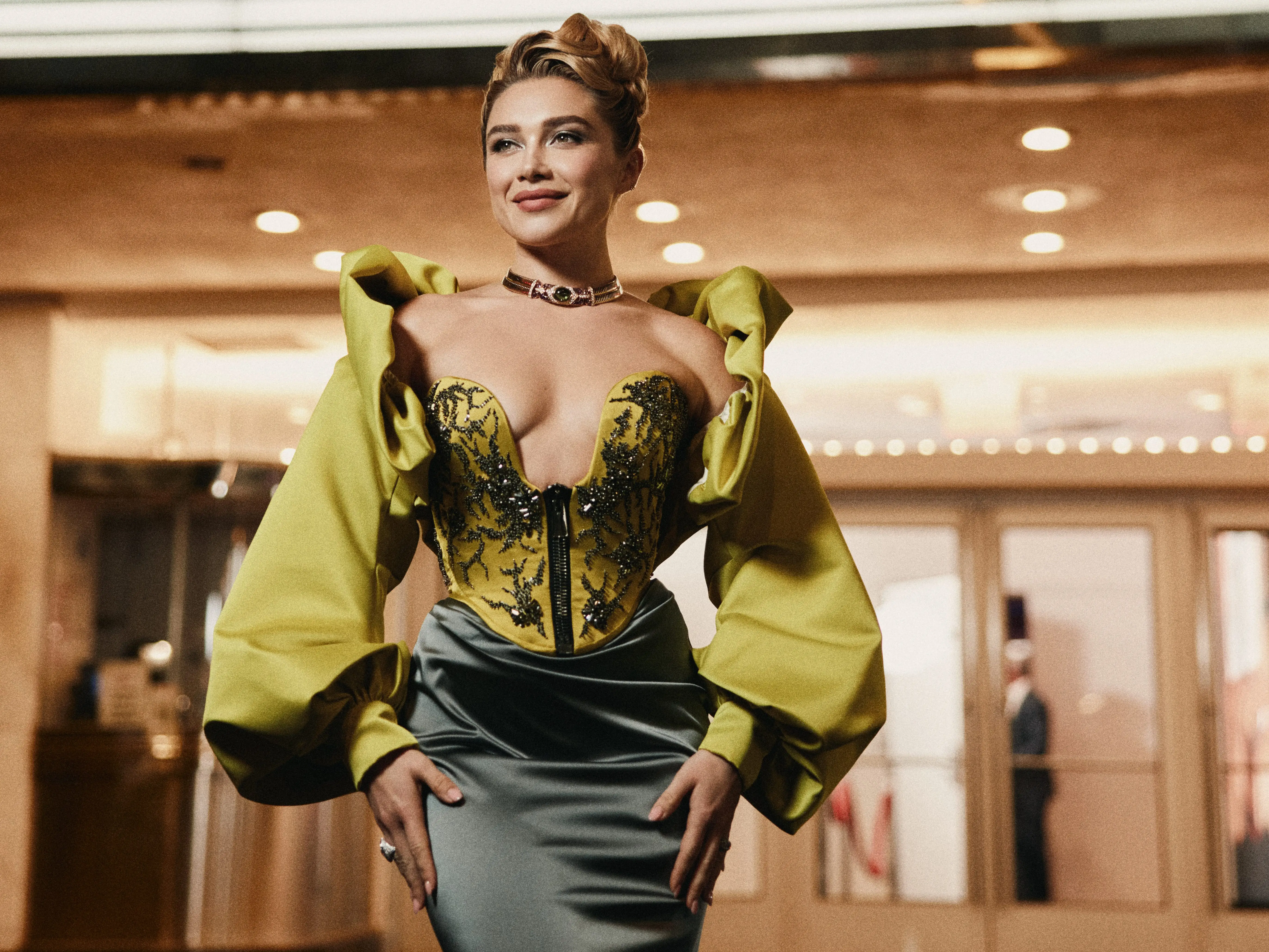 Florence Pugh poses beneath a Paris marquee displaying 