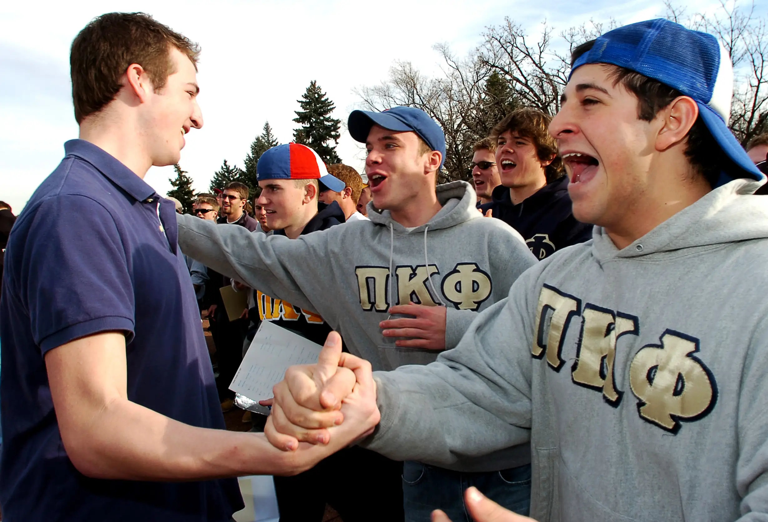 Febuary 04, 2006 (Boulder, CO)  Chris Wittenborn (cq)(M), sophomore in finance, and Greg Brouman (cq)(R), junior in finance, both with Pi Kappa Phi fraternity,  welcome Chance Heath (cq)(L), freshman in international affairs, in to their fraternity during Bid Day at the University Memorial Center .