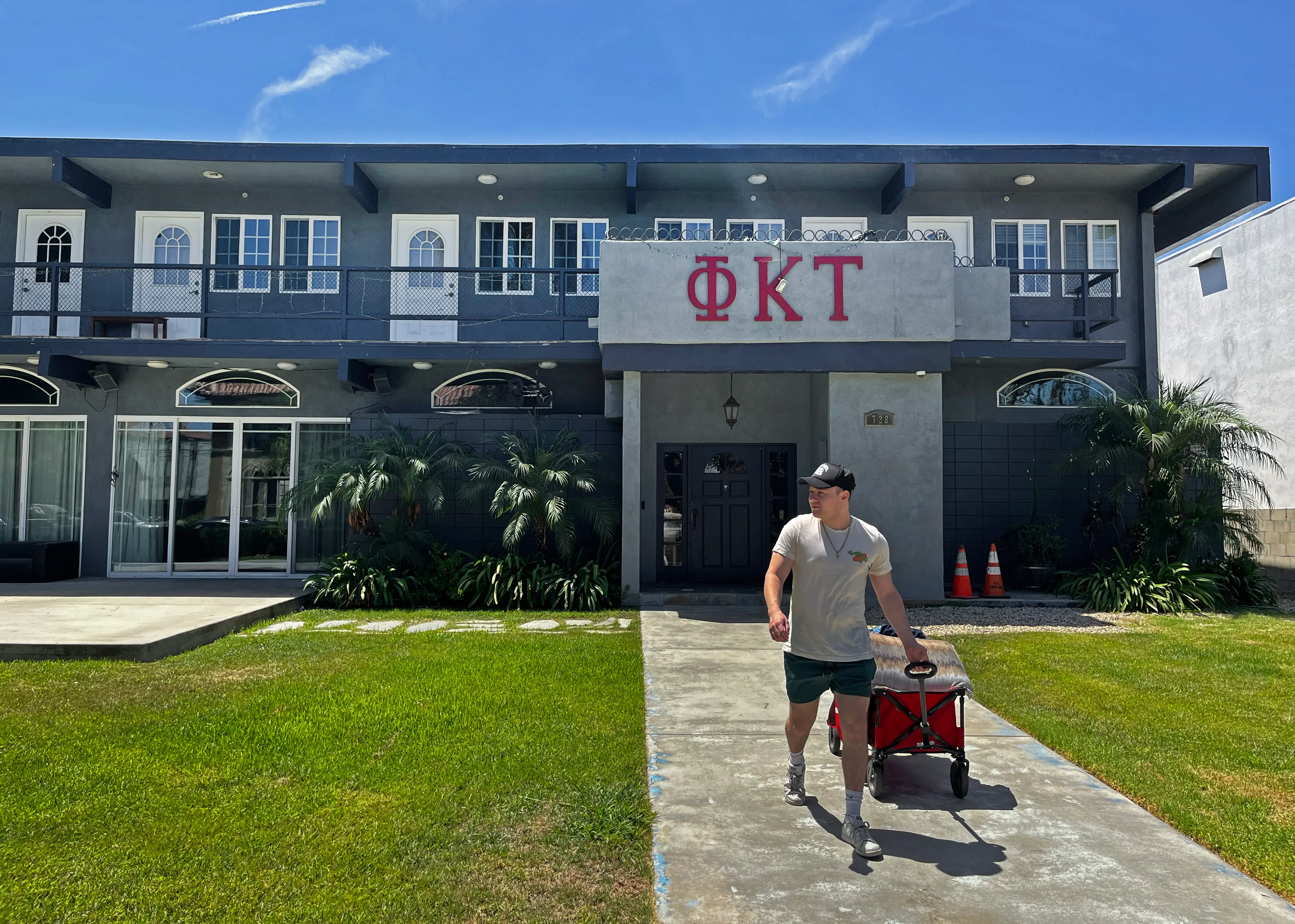 Isaac Ignatius, president of Phi Kappa Tau, moves belongings from a fraternity house.