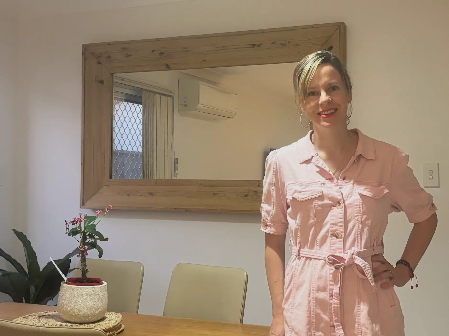 the author standing in front of a dining table