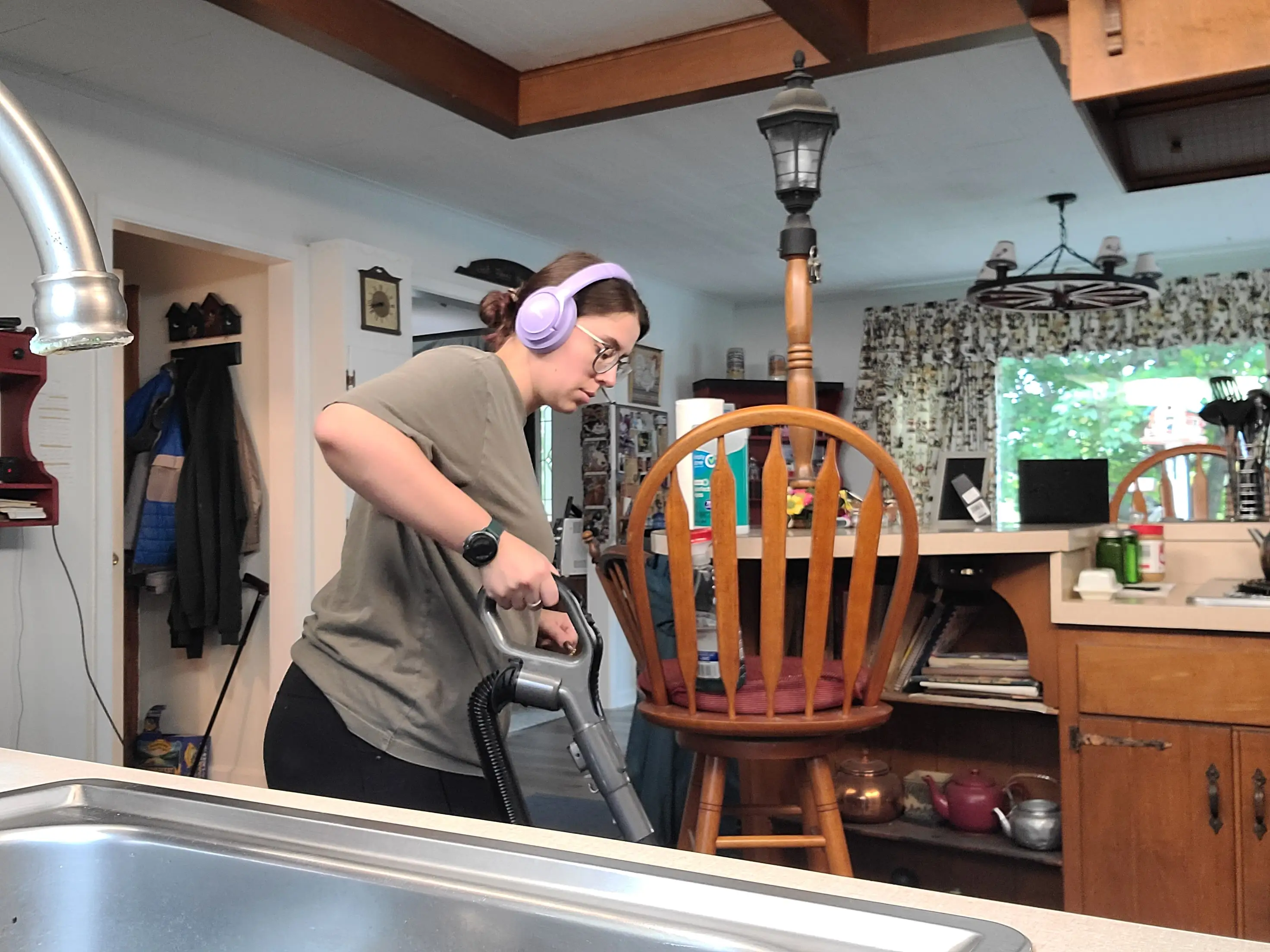 Woman with headphones vacuuming