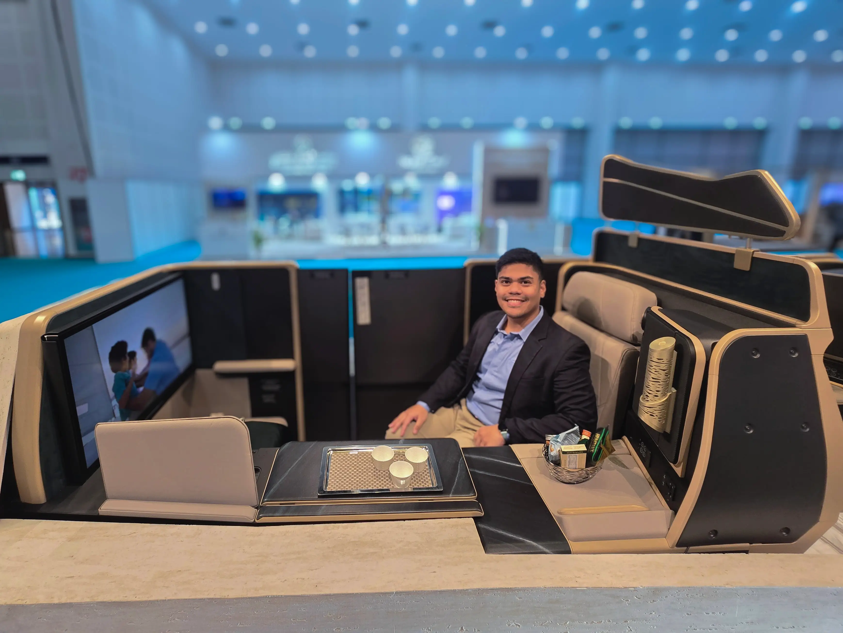 The author sitting in the beige and brown Etihad first class mockup.