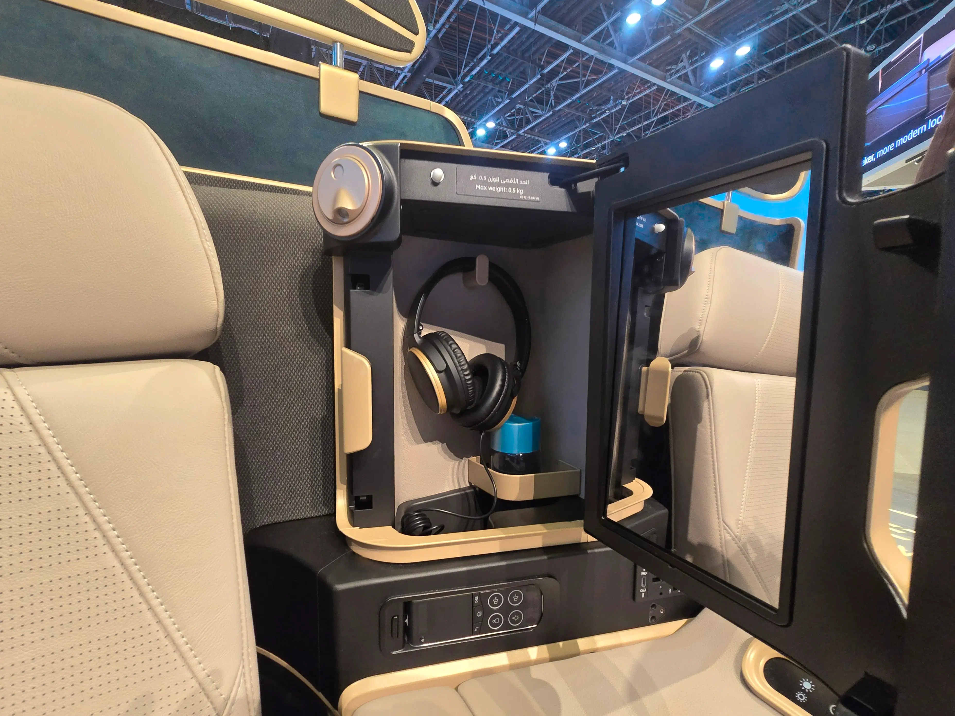 The cubby and headphones in business class.