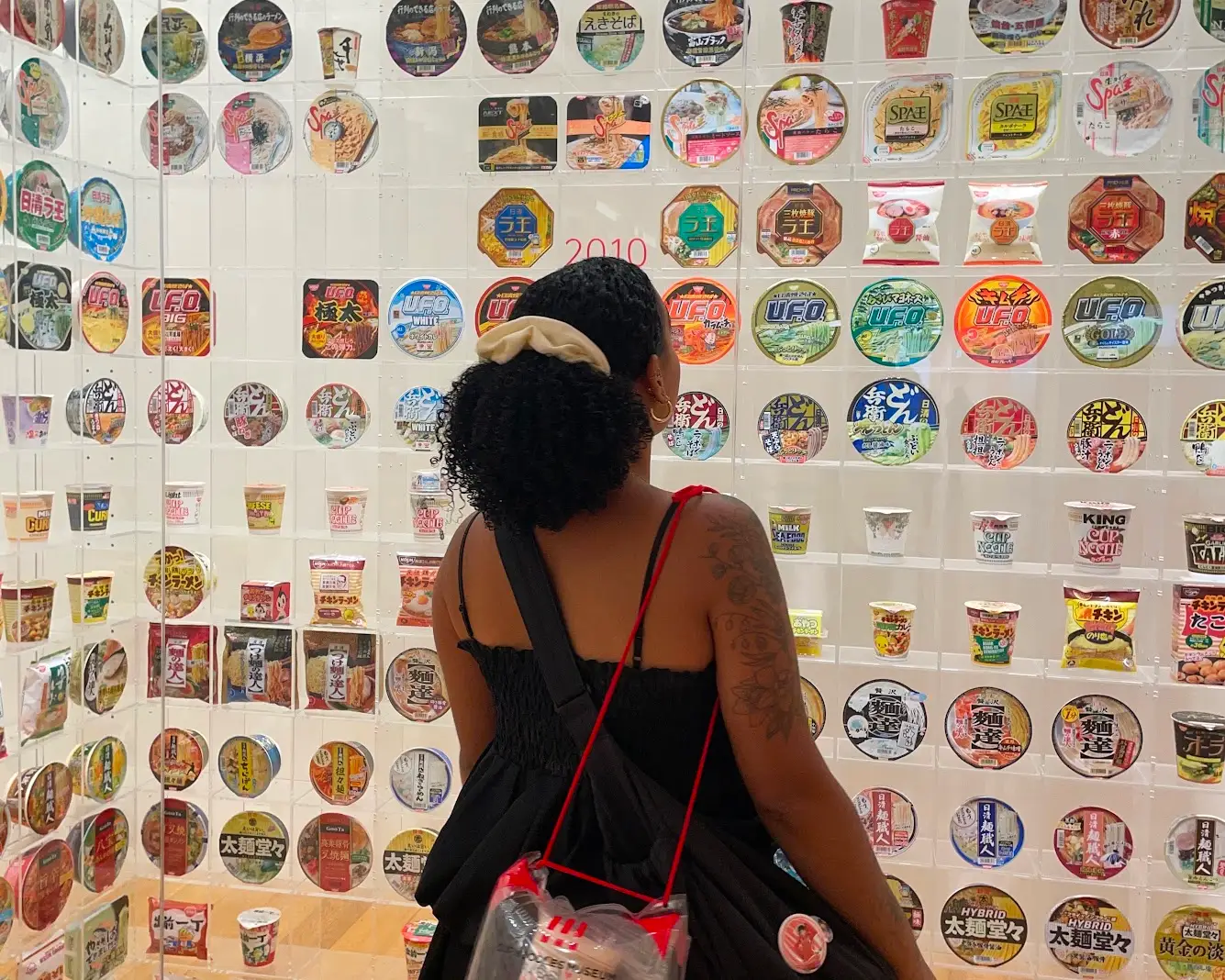 The writer looks at bowls of instant ramen at a museum in Japan.