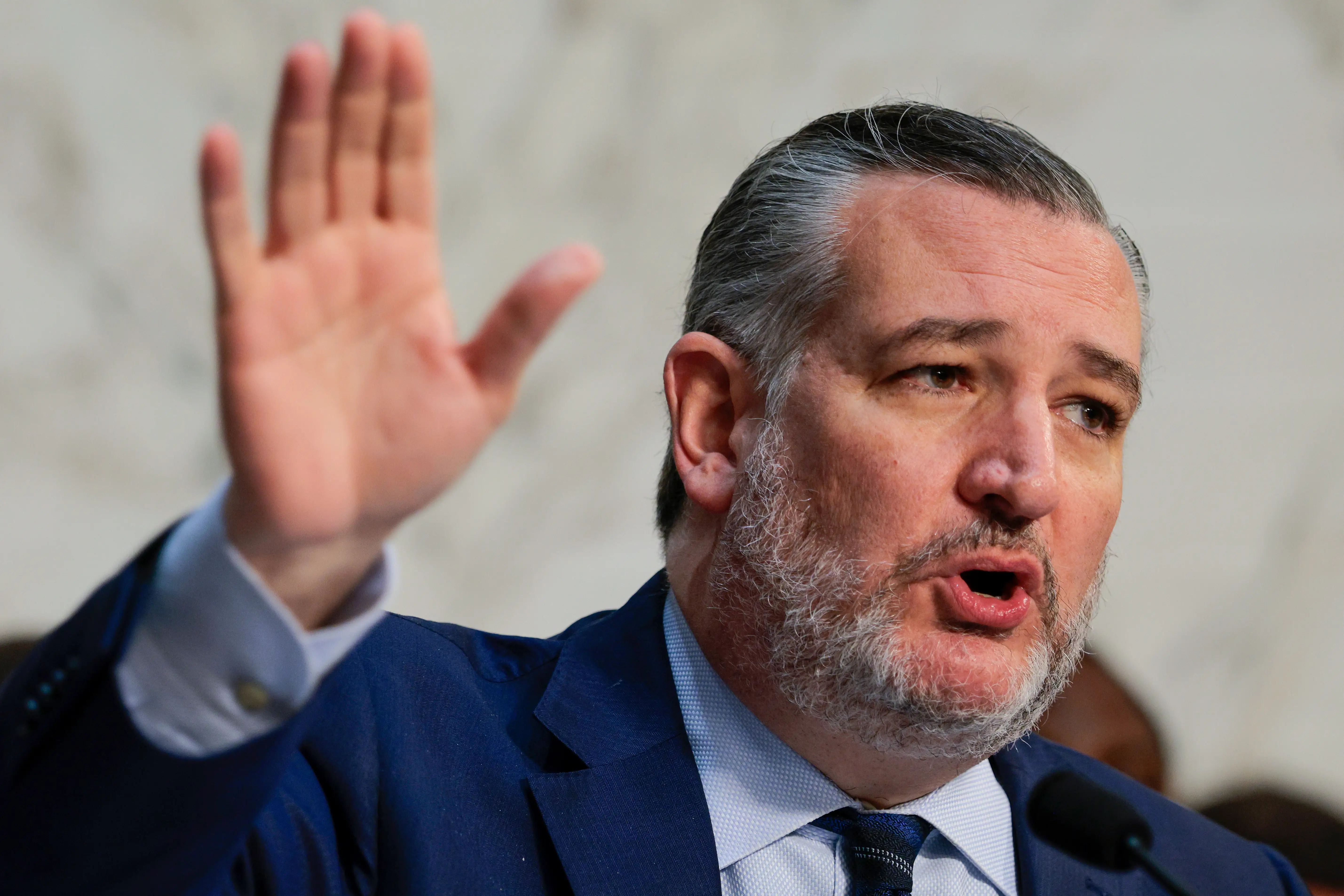 A man in a suit speaks.