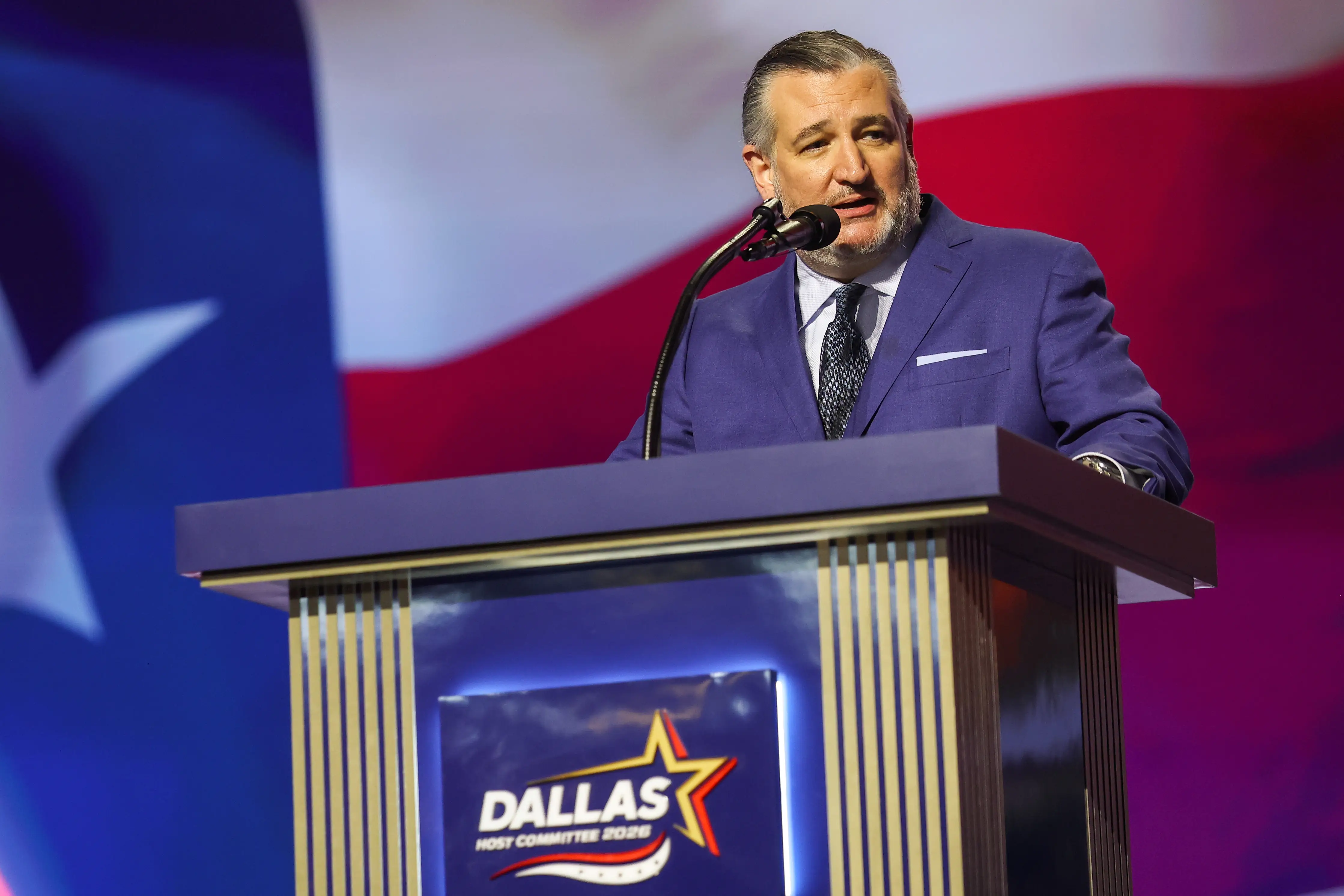 A man in a suit speaks.