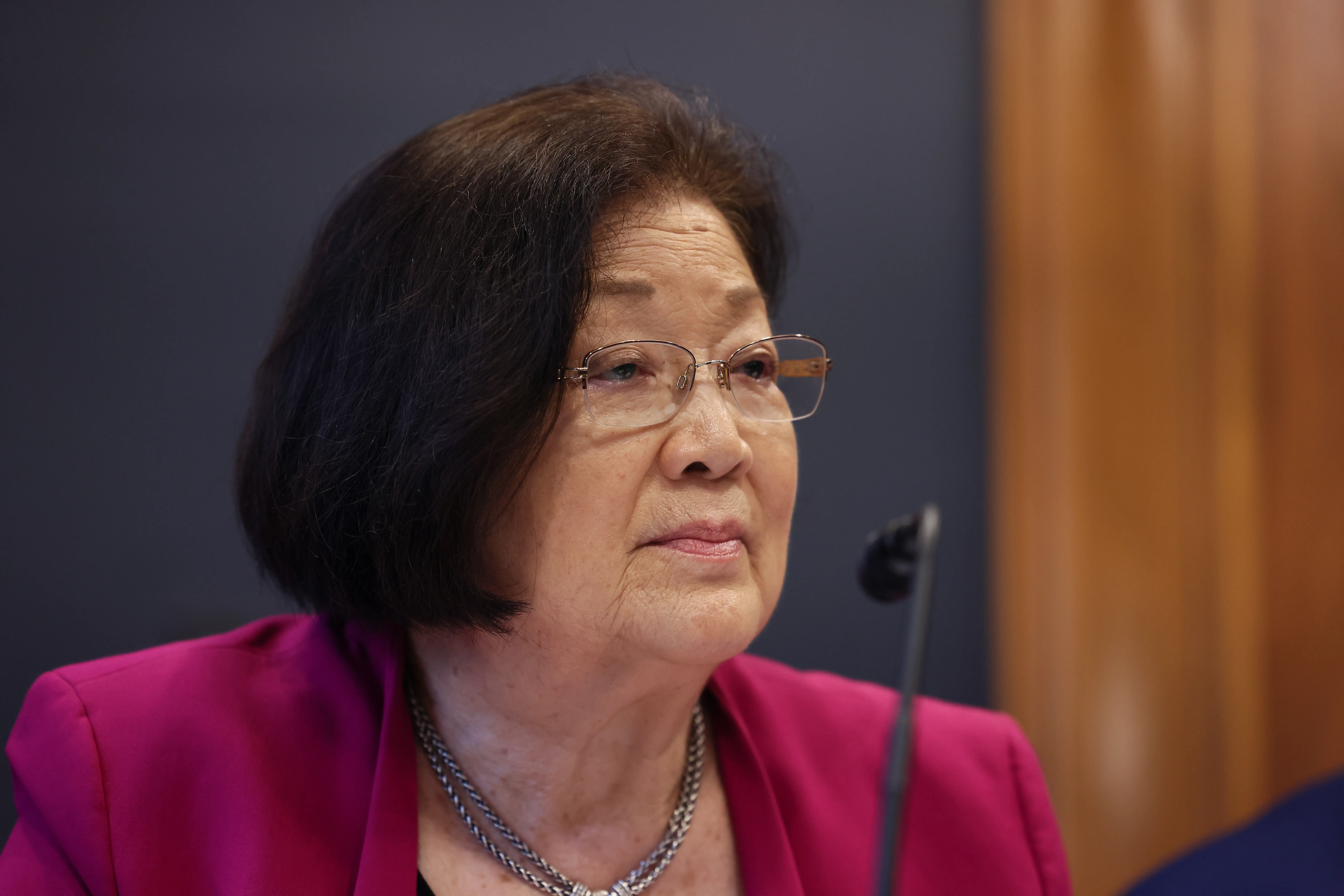A woman in a pink suit.