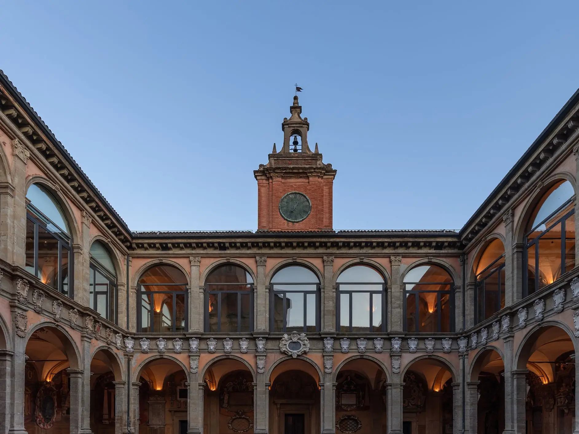 The main entrance to the University of Bologna features a large clock tower.