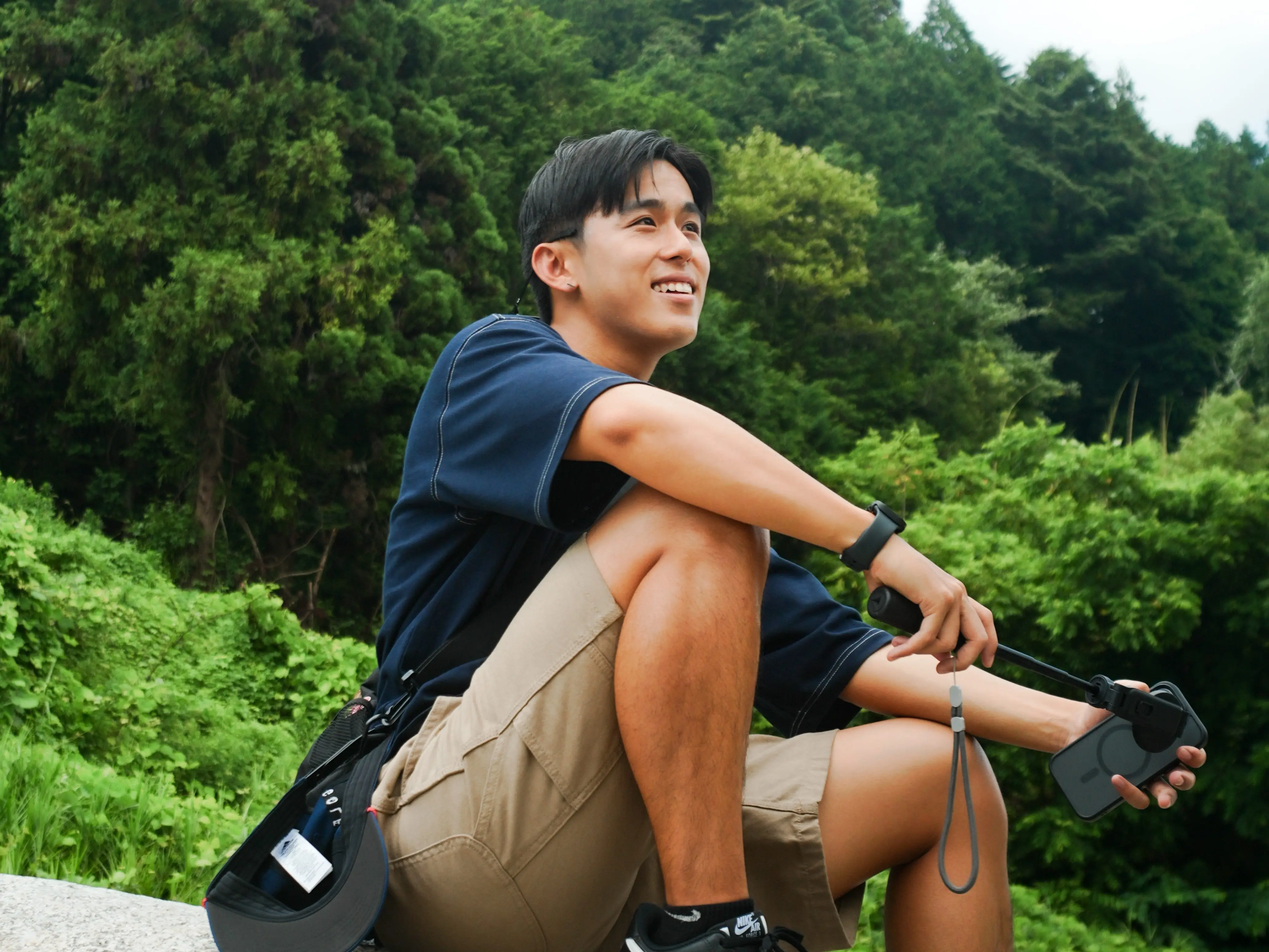 A man sitting on a rock.