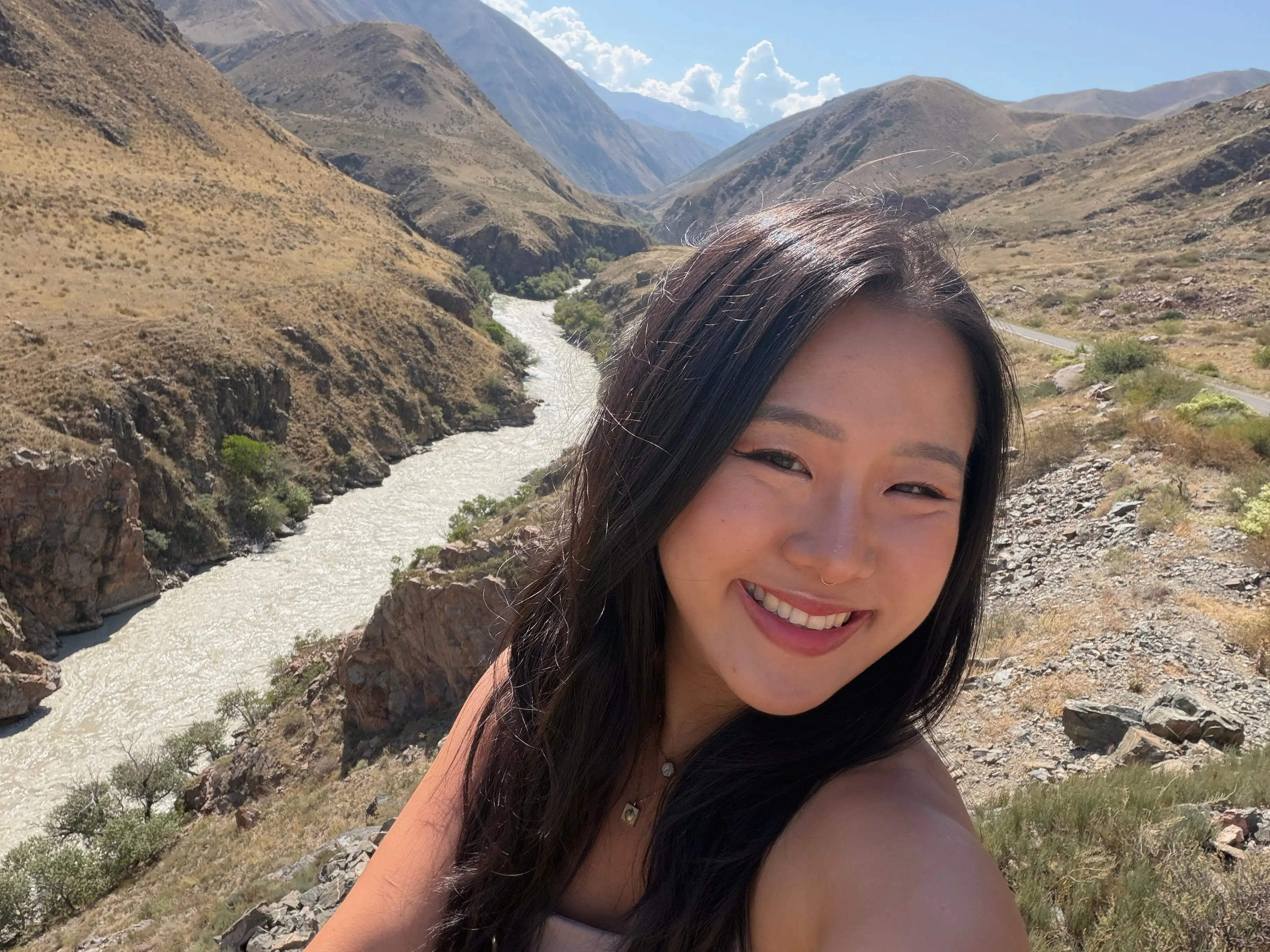 A woman taking a photo of herself on a hike.