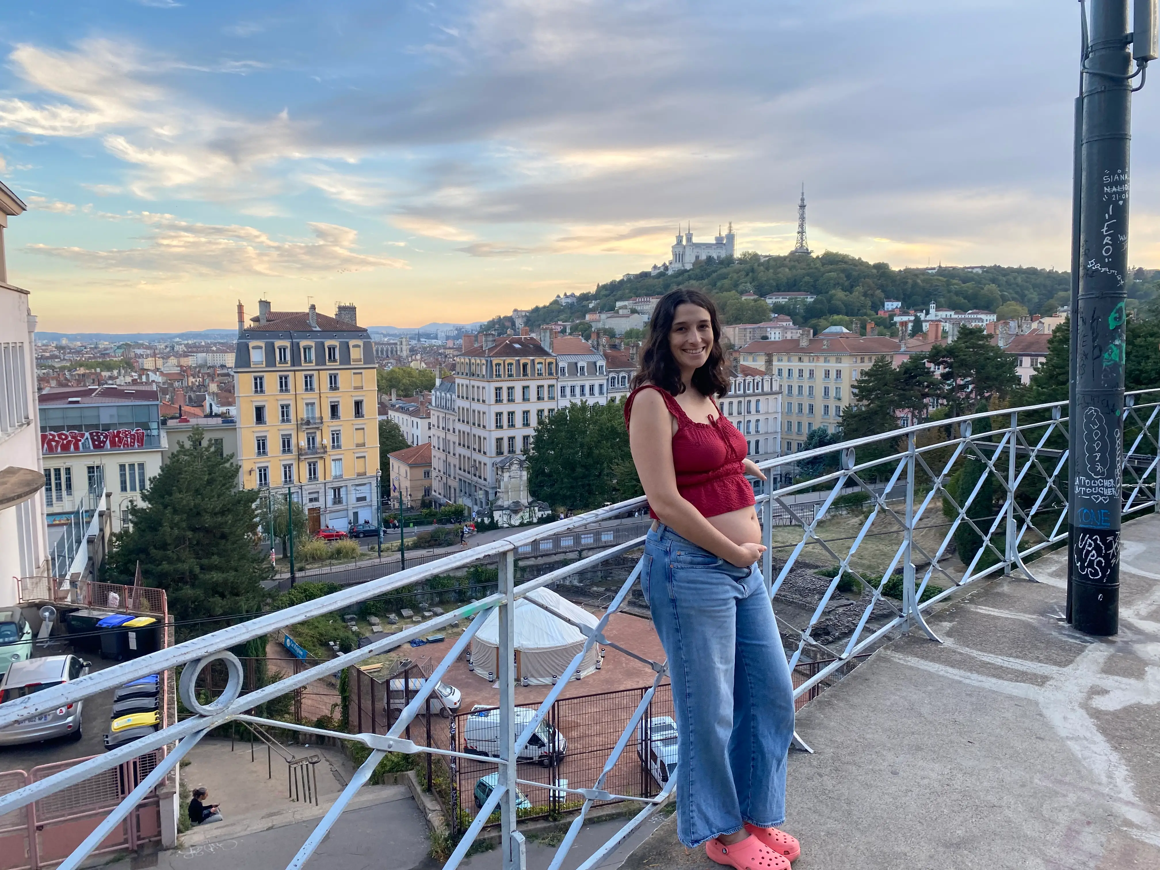 The writer stands on a hillside balcony overlooking Lyon rooftops.
