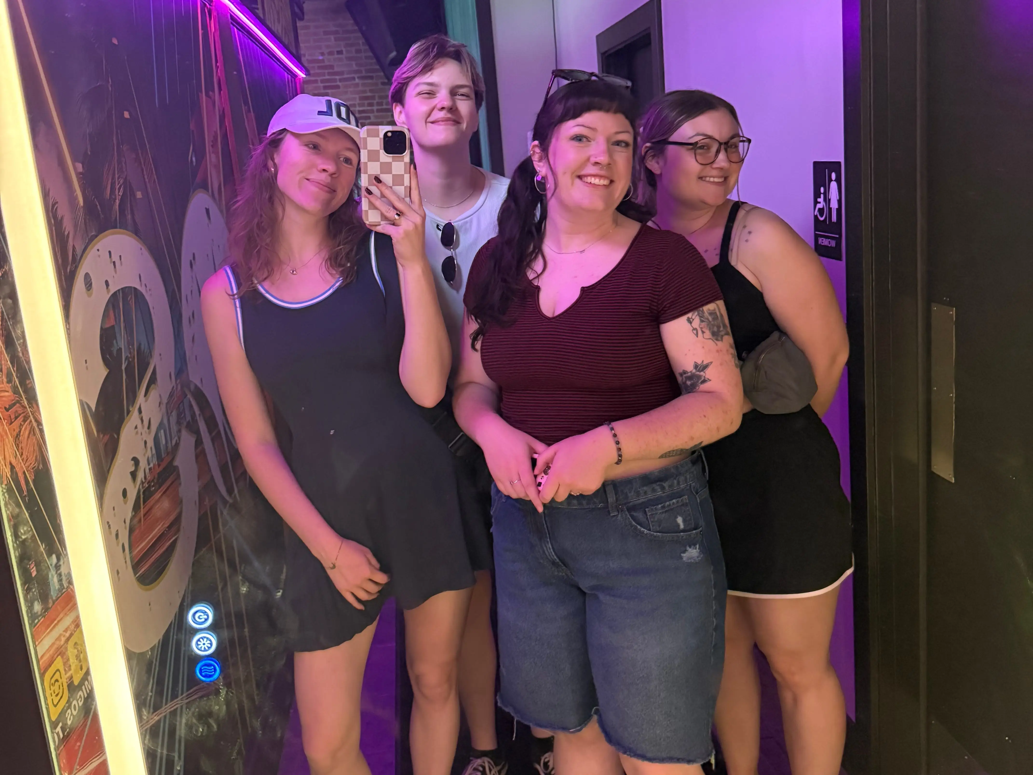 The writer, her girlfriend, and two roommates pose for a selfie.