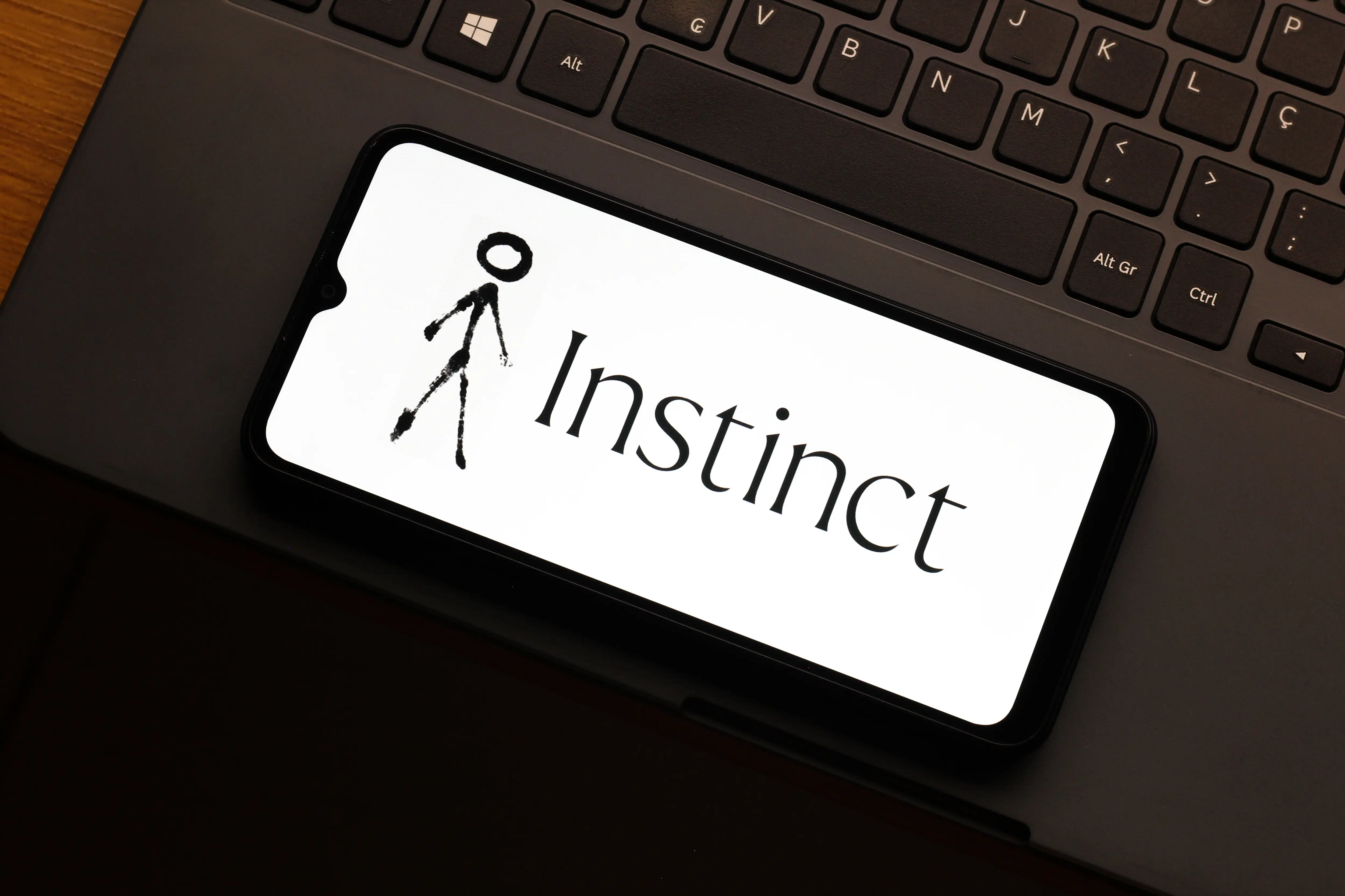 Instinct AI logo displayed on a smartphone screen