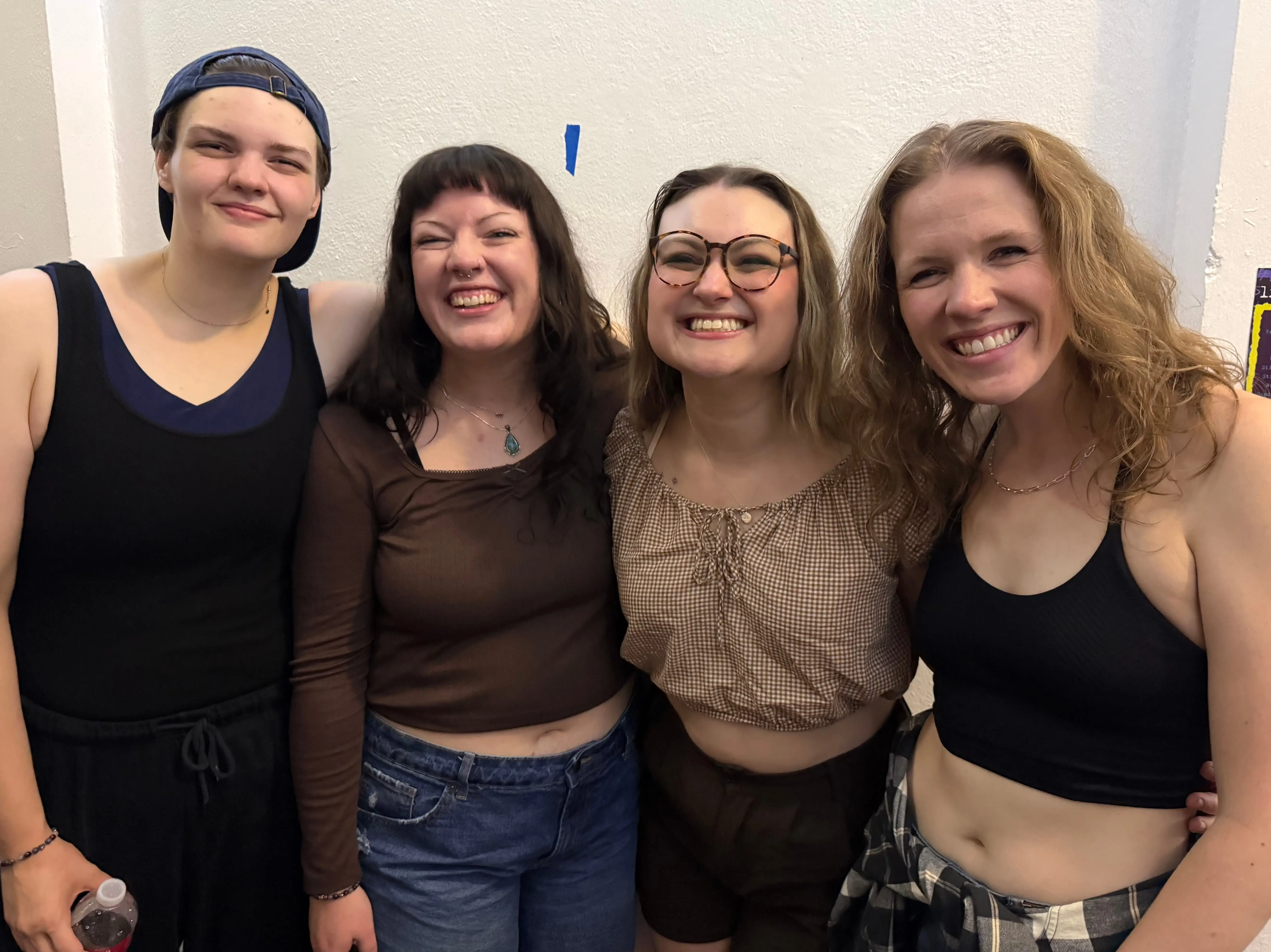 The writer is posing with her girlfriend and two roommates.