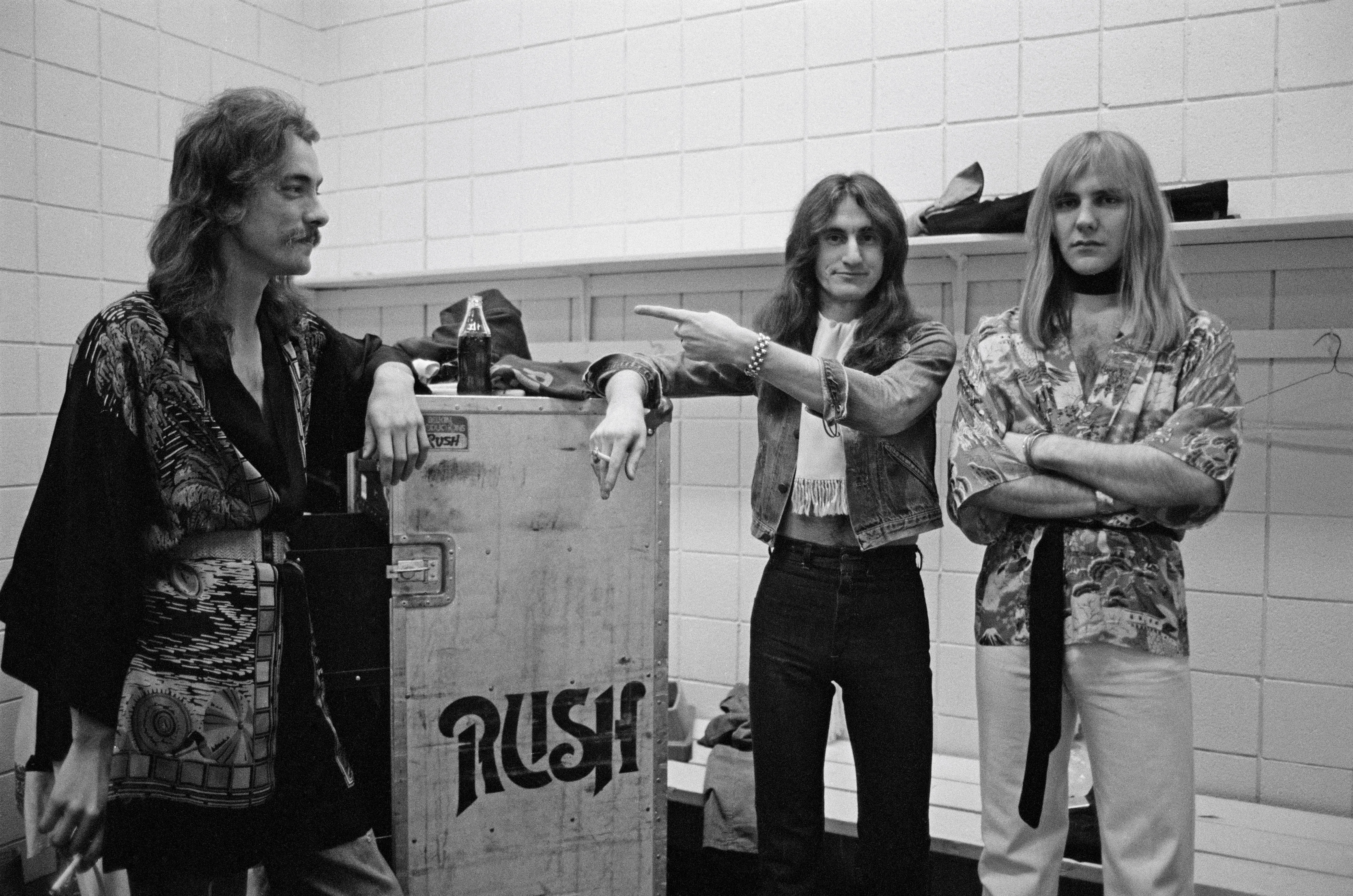 Original members of Rush pose backstage.