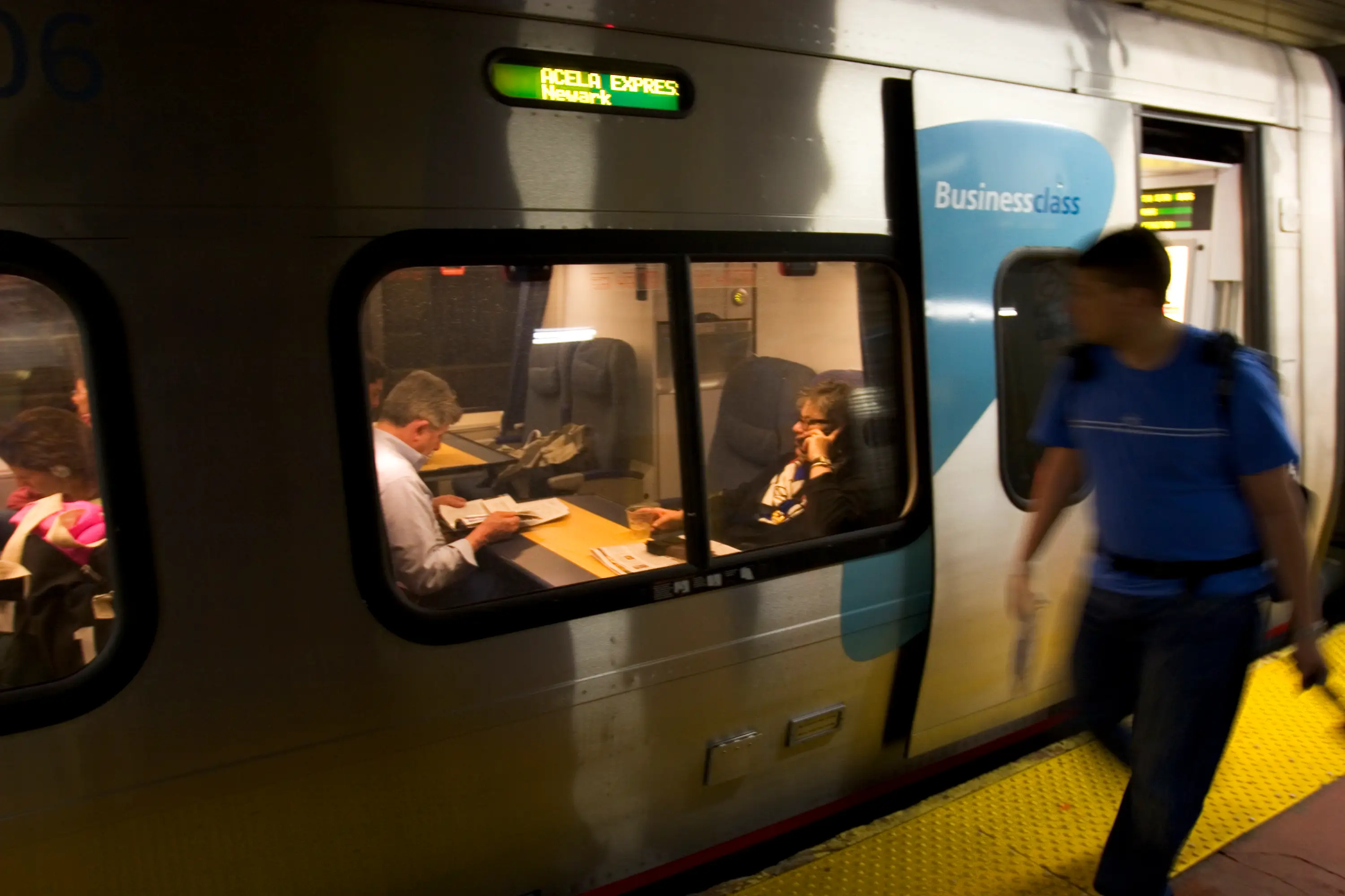 Passengers use their cell phones on Acela trains.