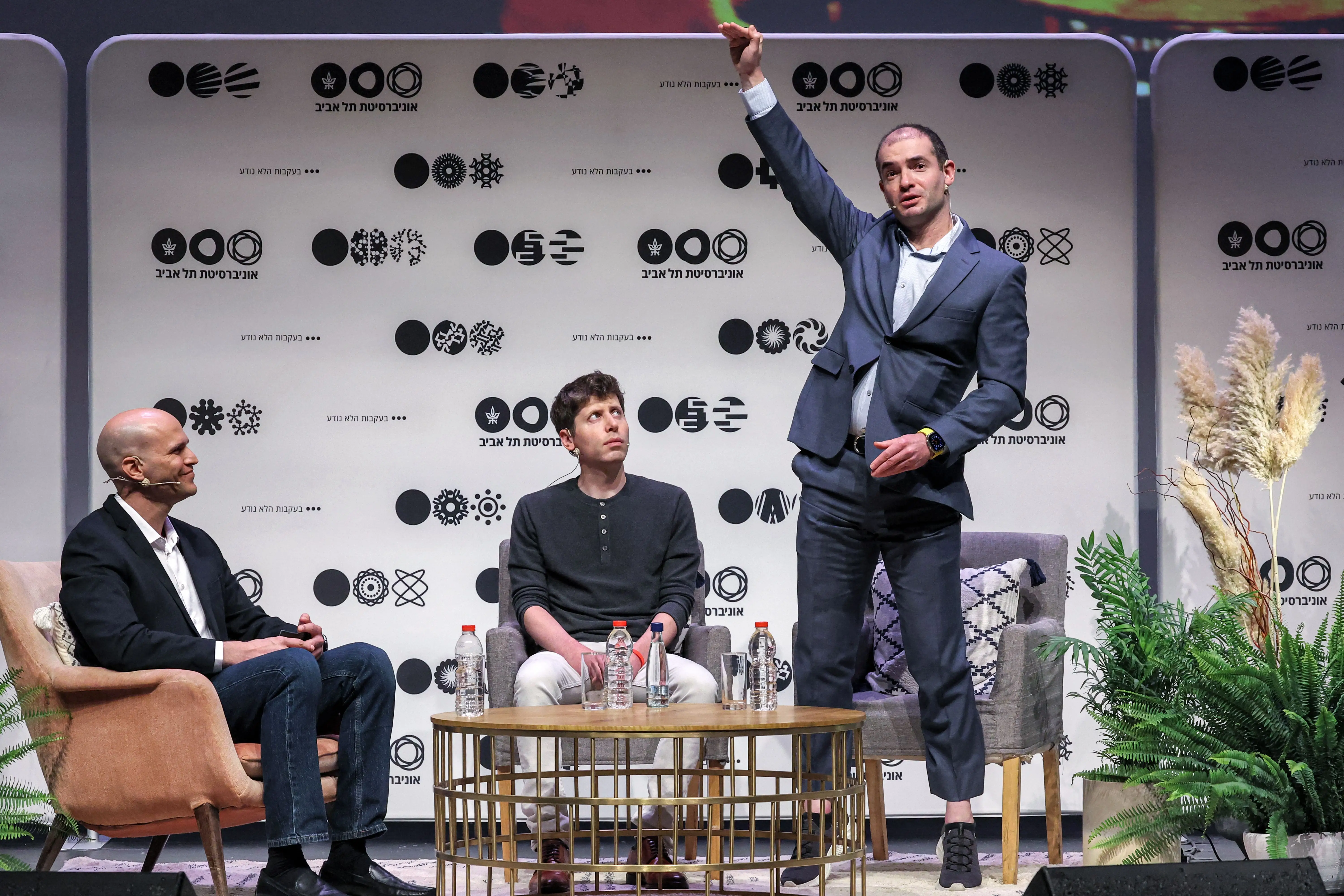 Sam Altman looks at Ilya Sutskever