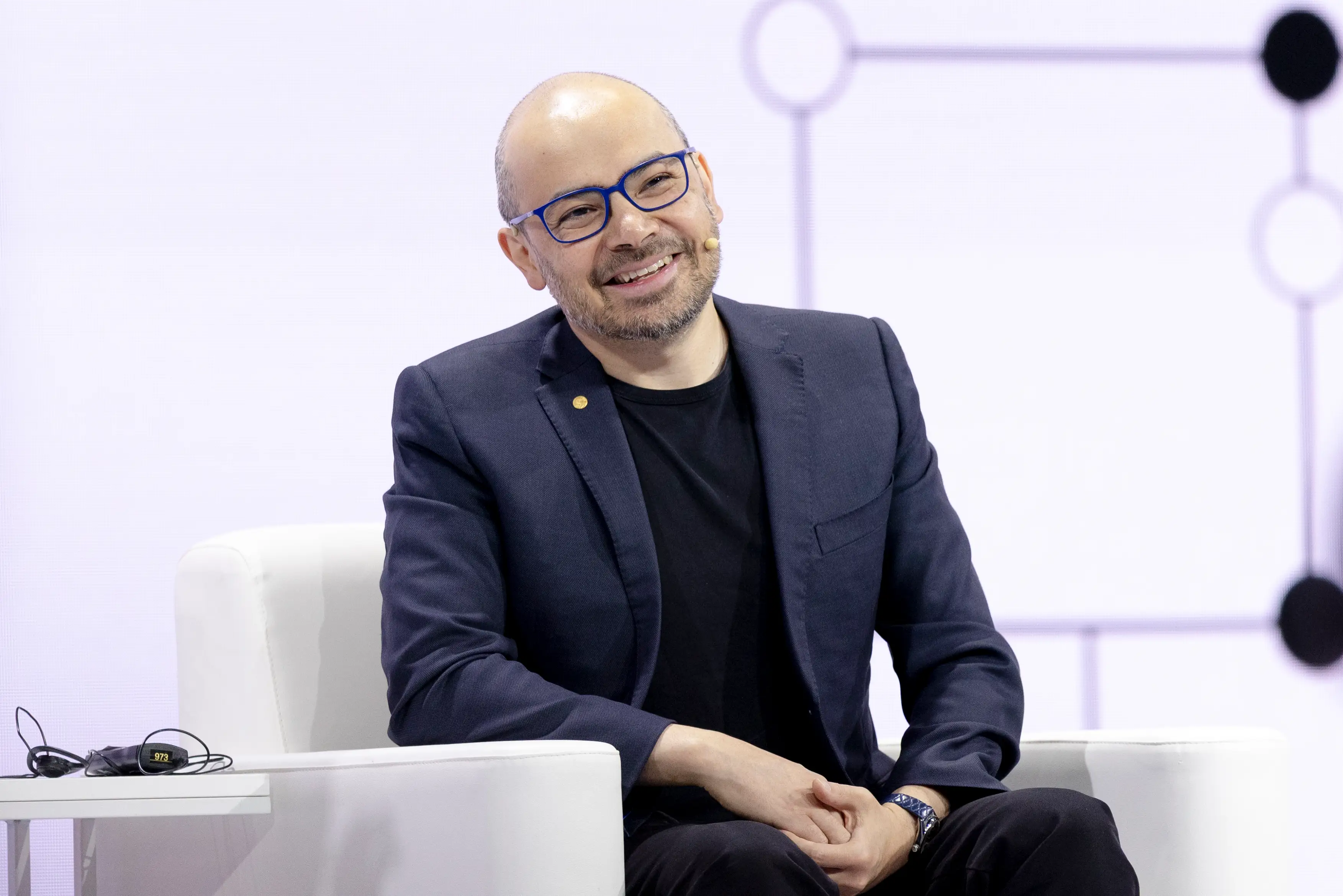 Demis Hassabis smiles during an event