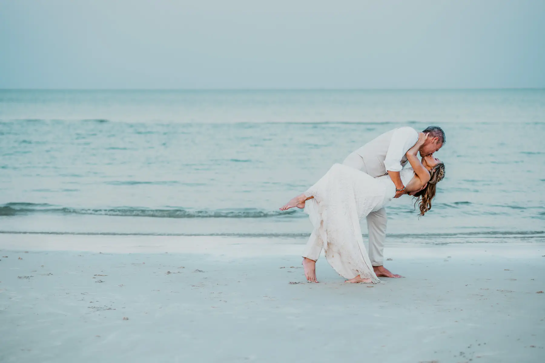 A couple having a wedding kiss on the beach in Cambodia.