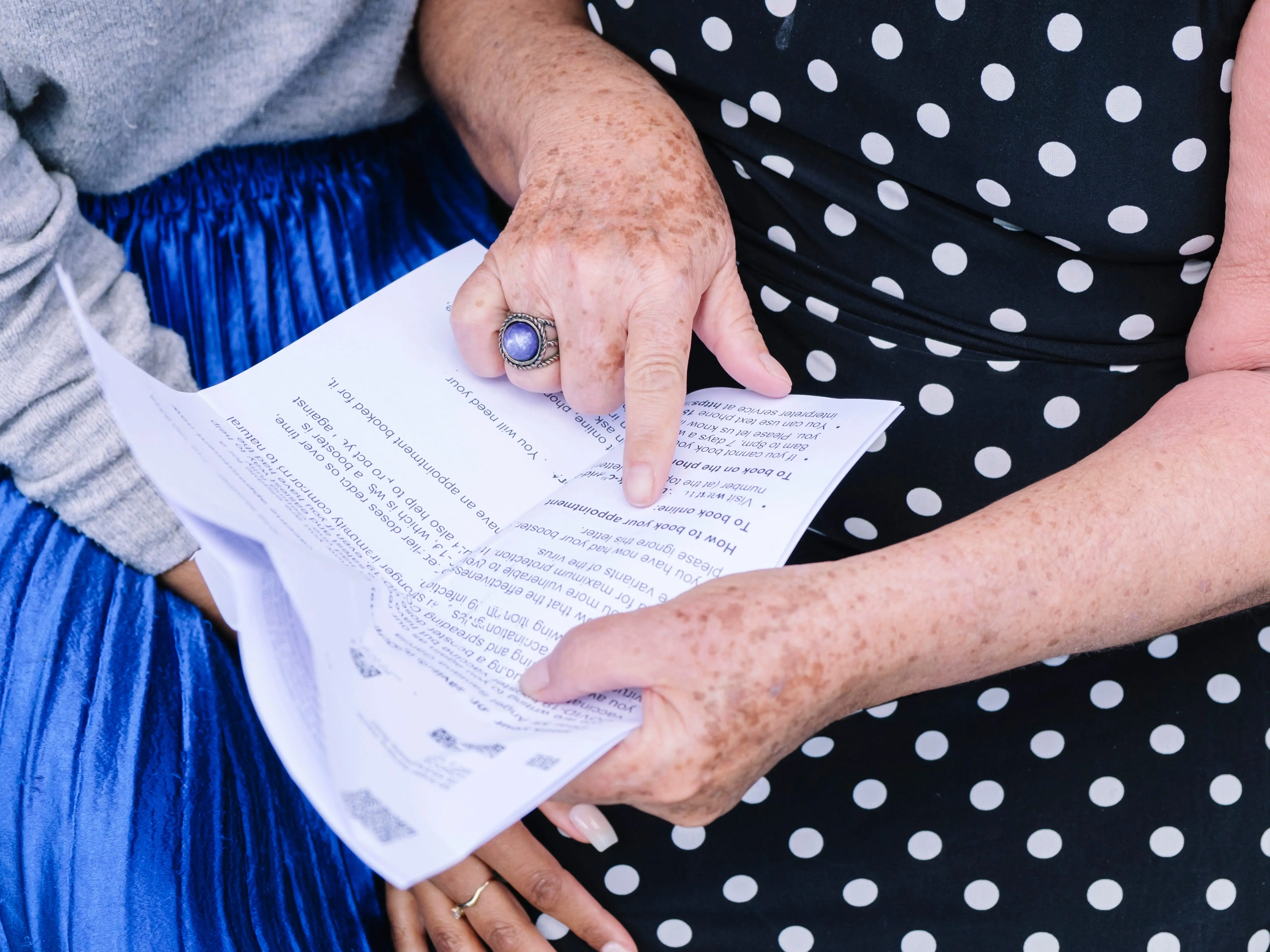 close up of an older and younger woman reviewing a document