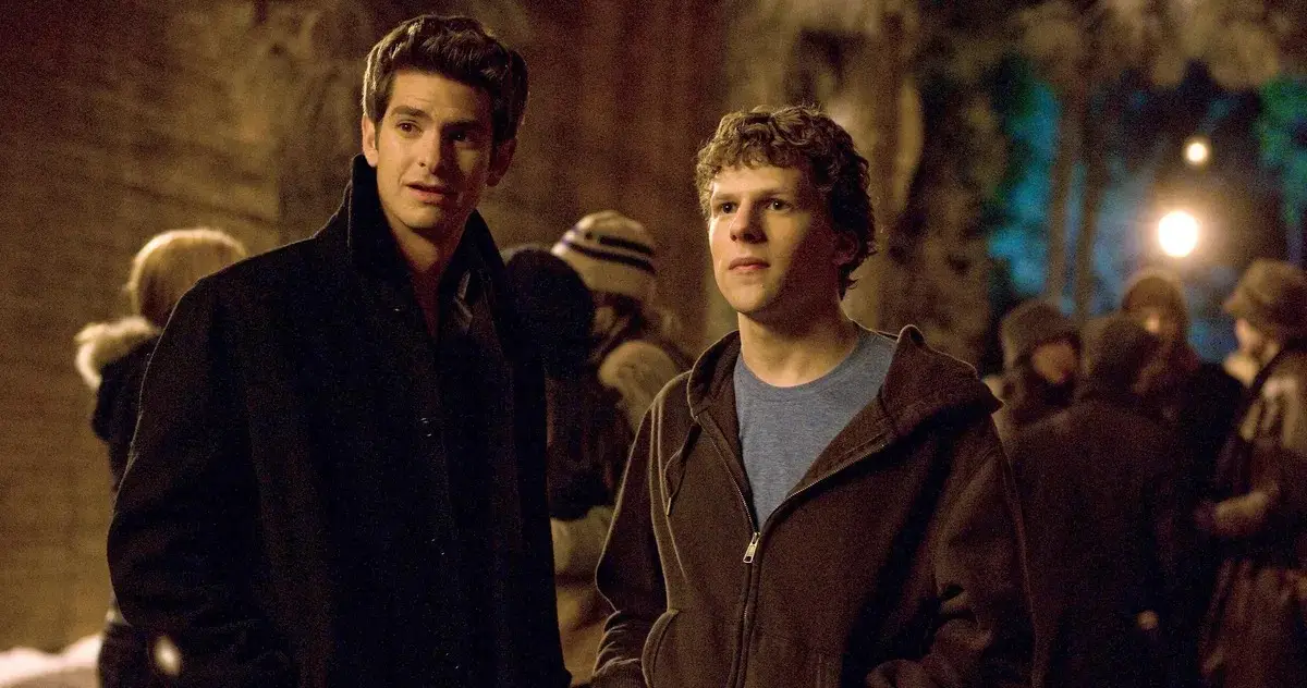 Andrew Garfield and Jesse Eisenberg standing in a crowd
