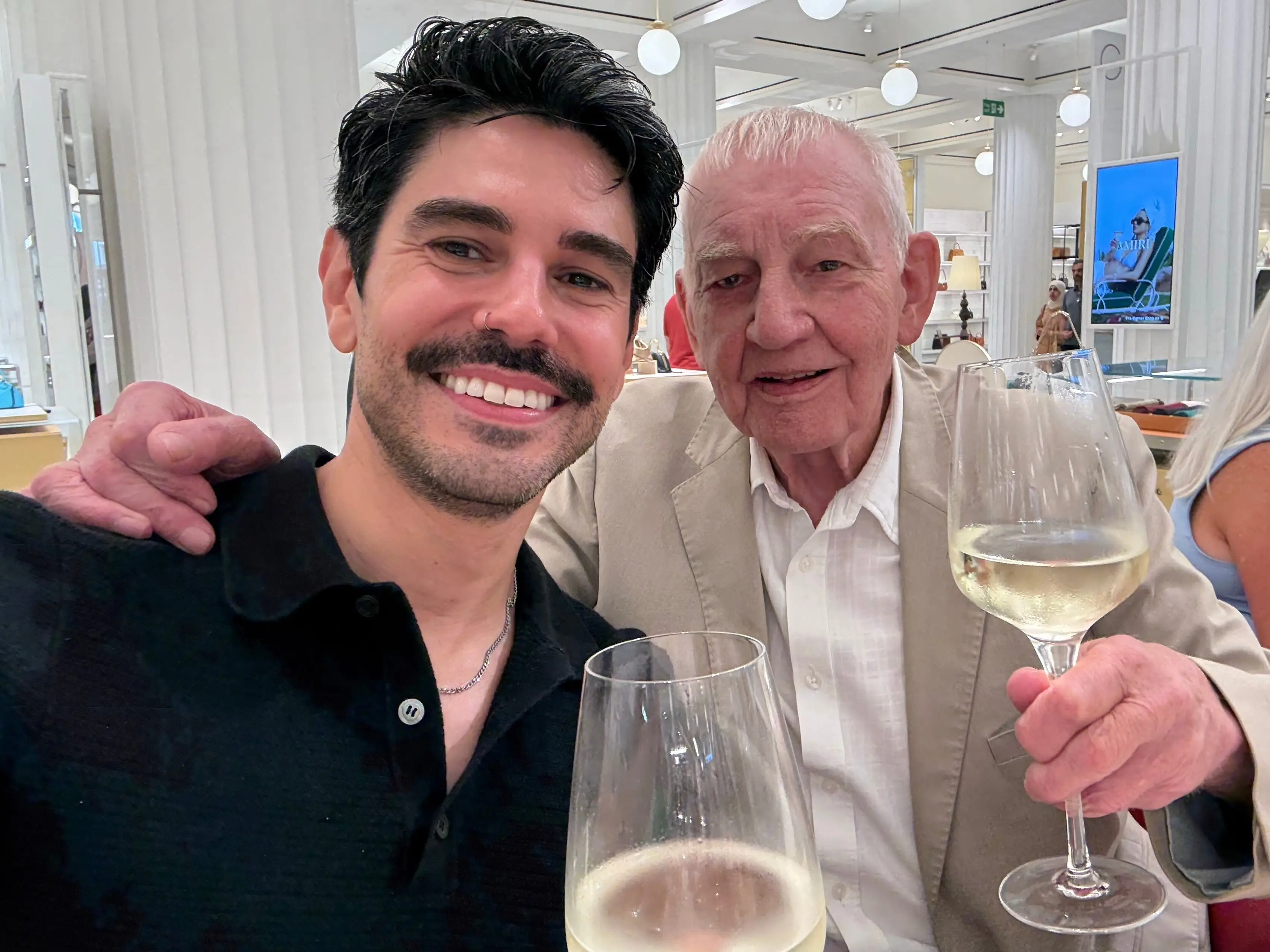 Sean and his uncle holding glasses of white wine.