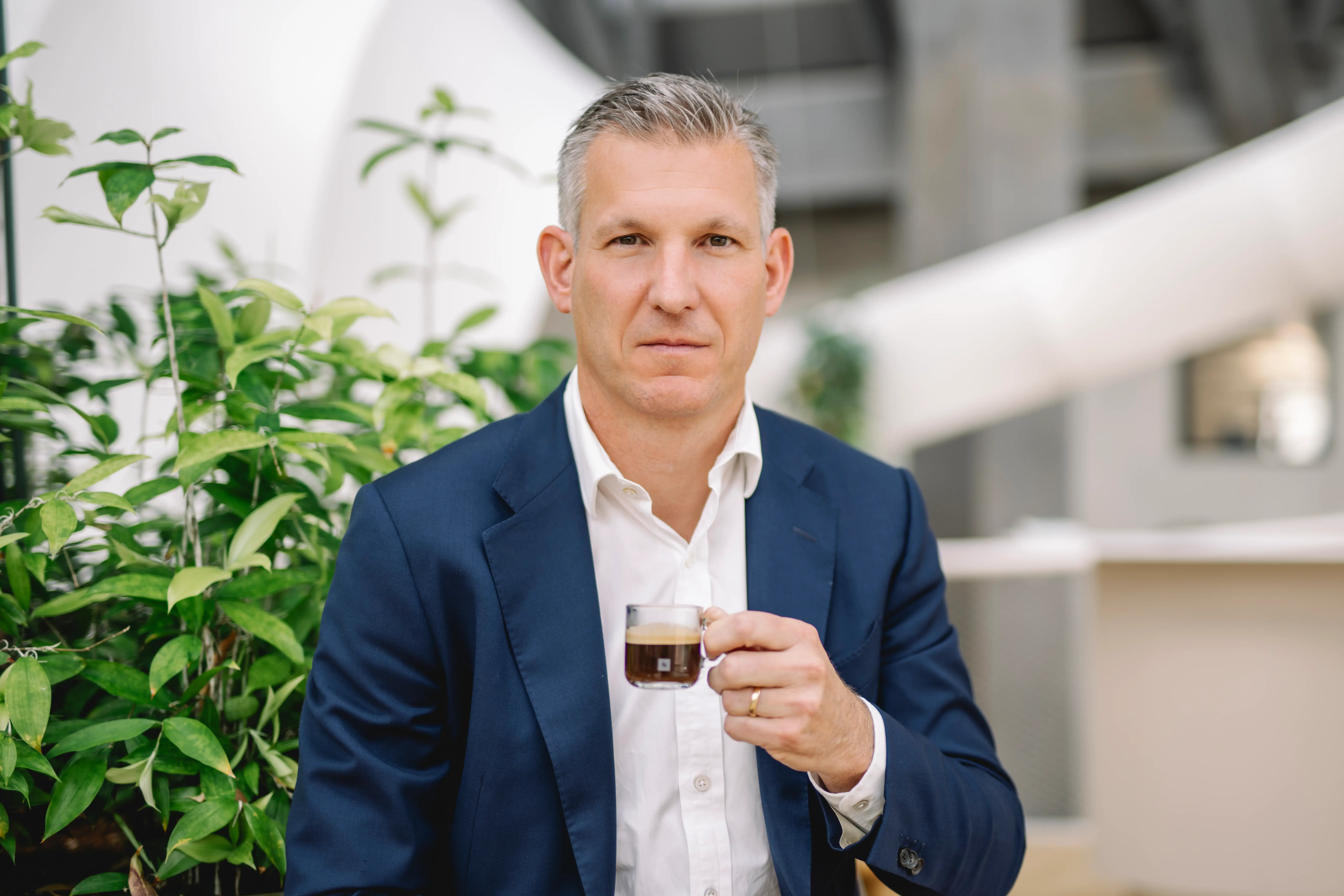Philipp Navratil holding coffee.