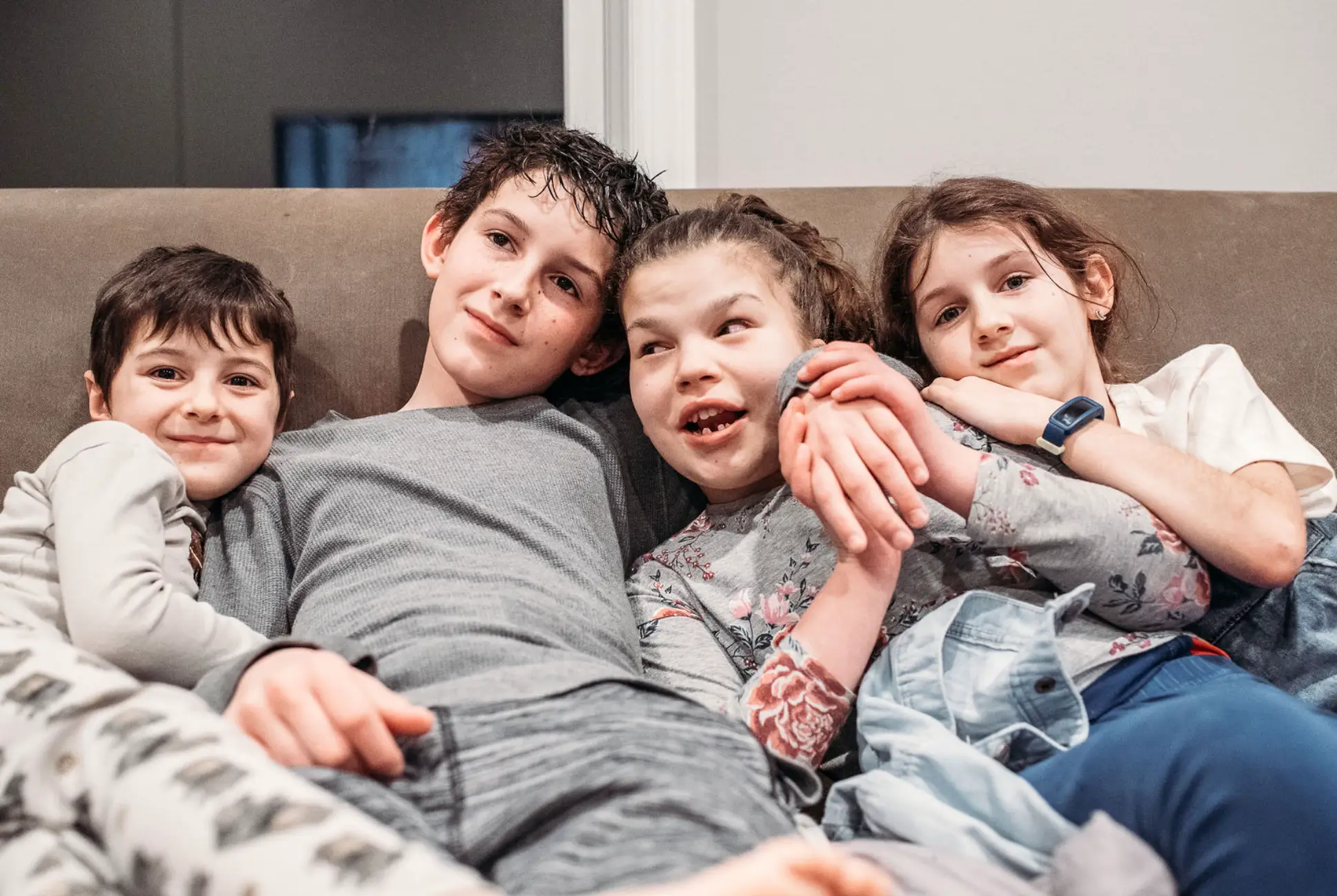 the author's four kids sitting on a couch in pajamas