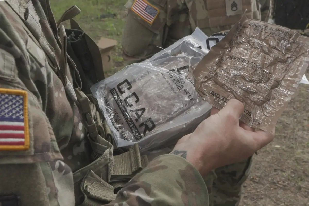 A soldier holds a Close Combat Assault Ration.