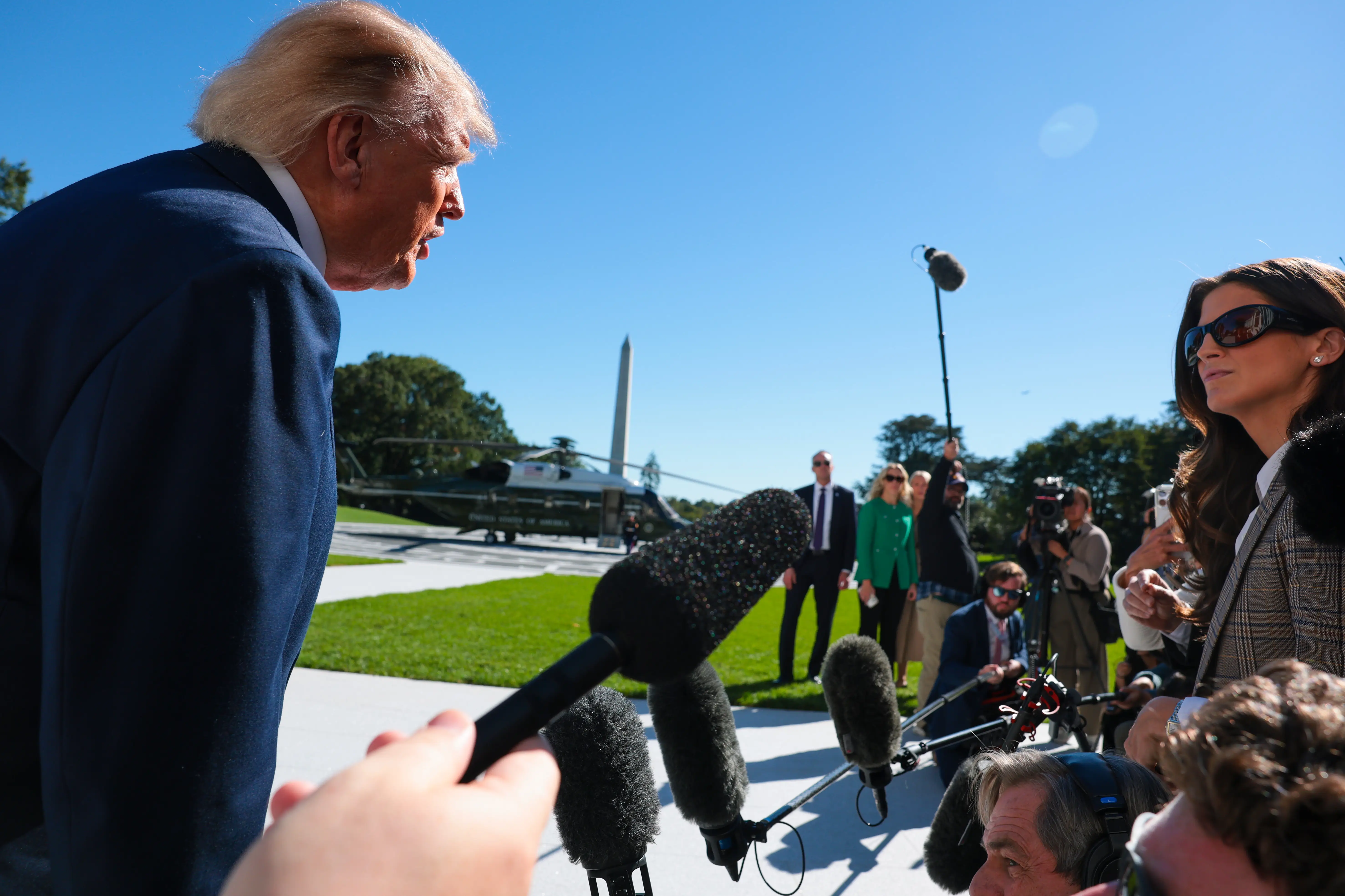President Donald Trump speaks to the news media including CNN news anchor Kaitlin Collins