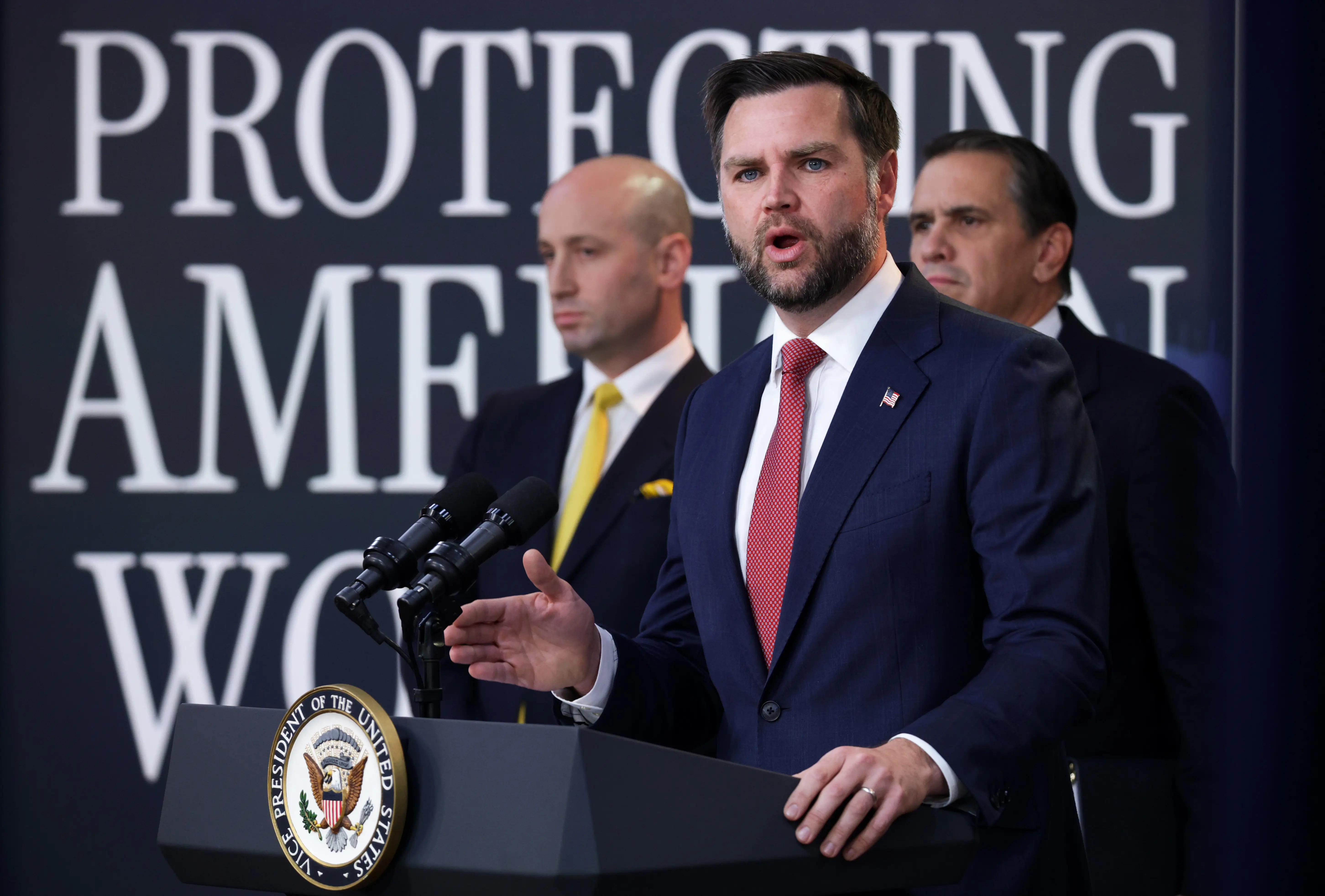 WASHINGTON, DC - OCTOBER 08: U.S. Vice President JD Vance speaks alongside White House Deputy Chief of Staff and Homeland Security Advisor Stephen Miller (L) and U.S. Attorney General Todd Blanche (R) during a Fraud Task Force press conference in the Eisenhower Executive Office Building at the White House on October 08, 2026 in Washington, DC. Vance announced new findings of alleged abuse and fraud in the H-1B temporary work visa and permanent labor certification (PERM) programs.