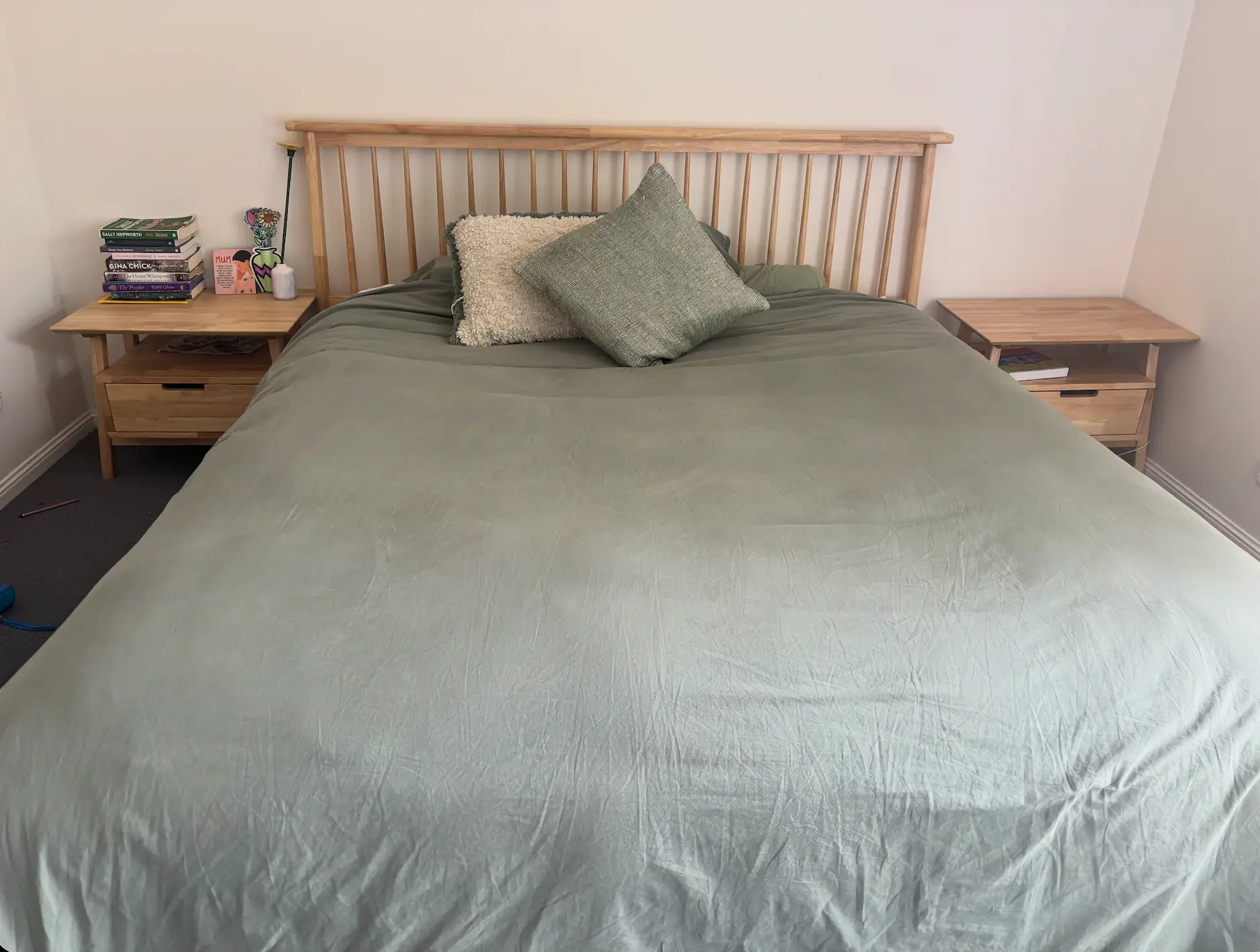 bedroom set with night stands, bed frame, and bed covered in light green bedding