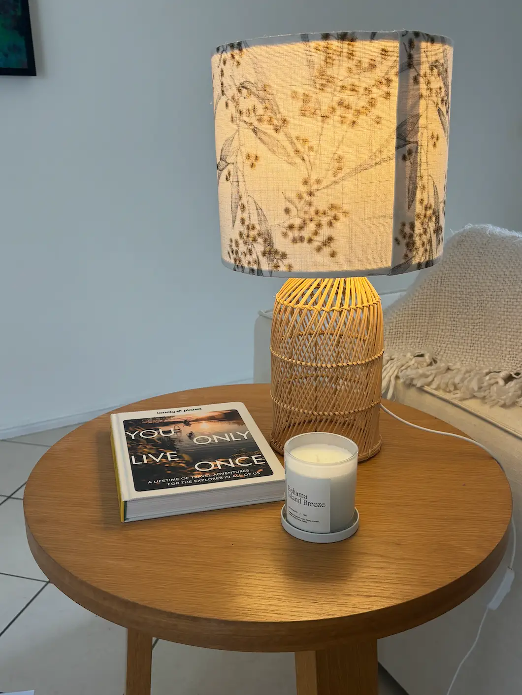 handmade lamp, candle, and book on a side table