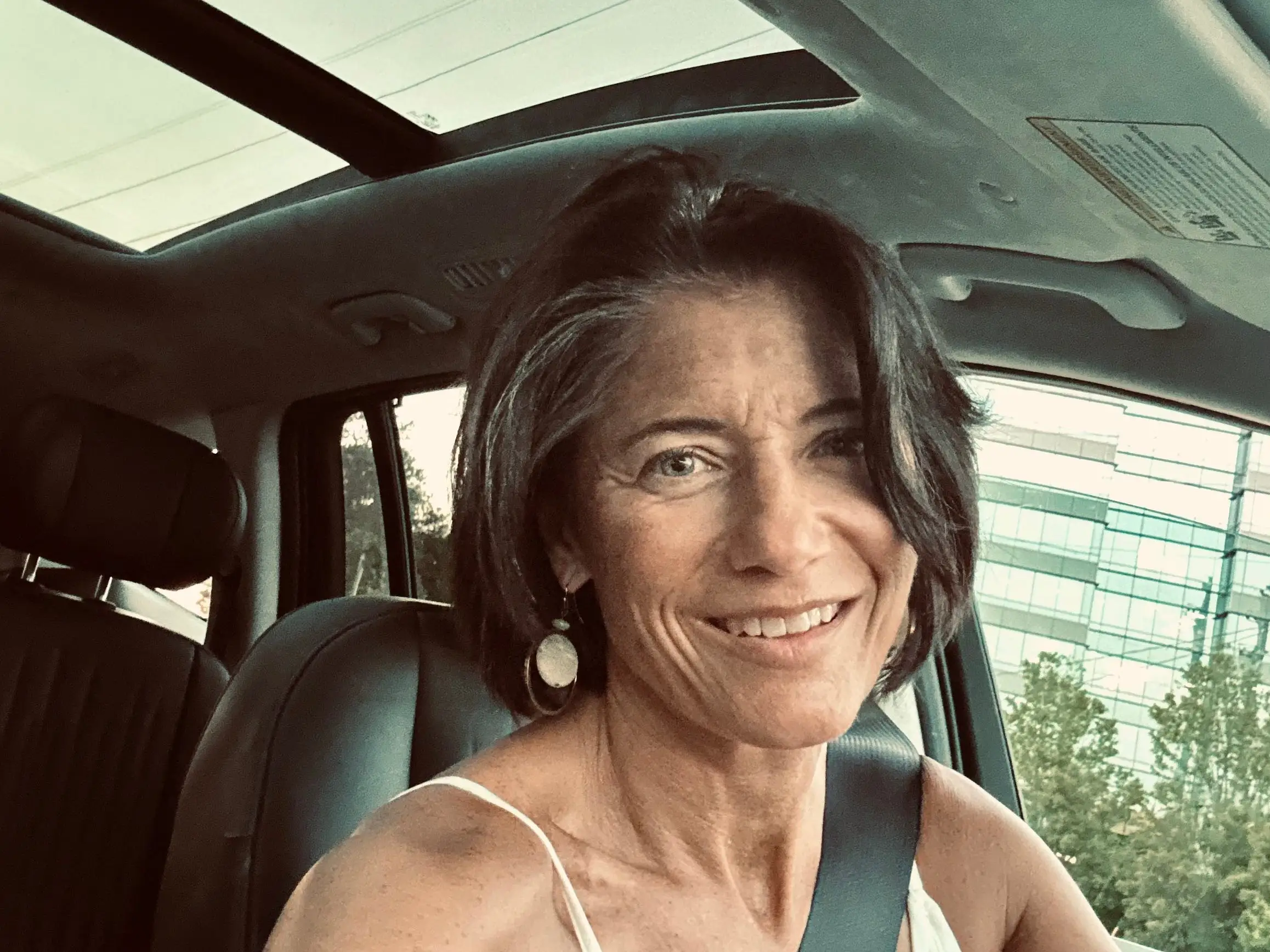 Erin Keating, Cox Automotive's executive analyst, in the driver's seat of her car.