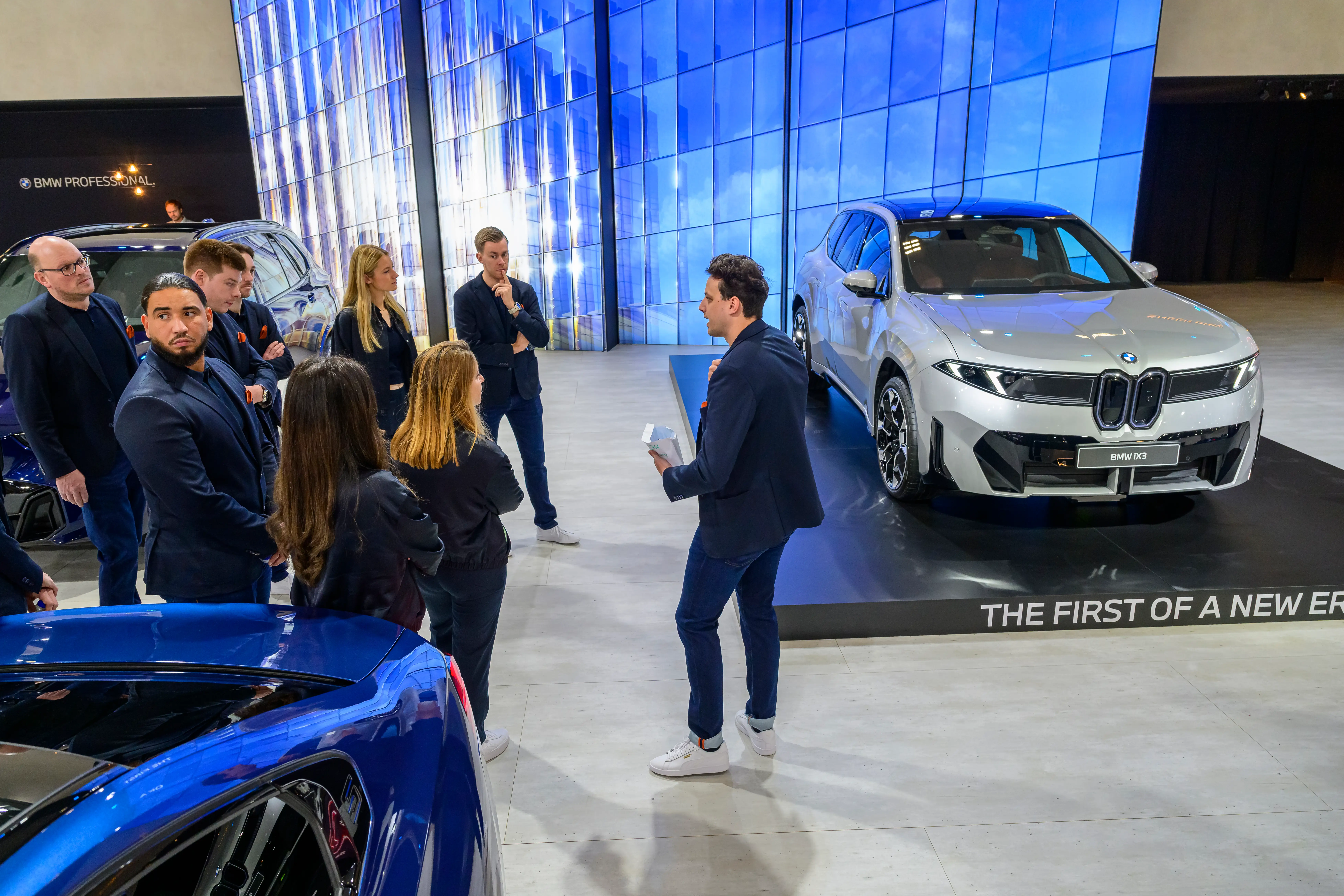 A silver BMW iX3 luxury crossover SUV on display at the AutoSalon press preview on January 09, 2026, in Brussels.