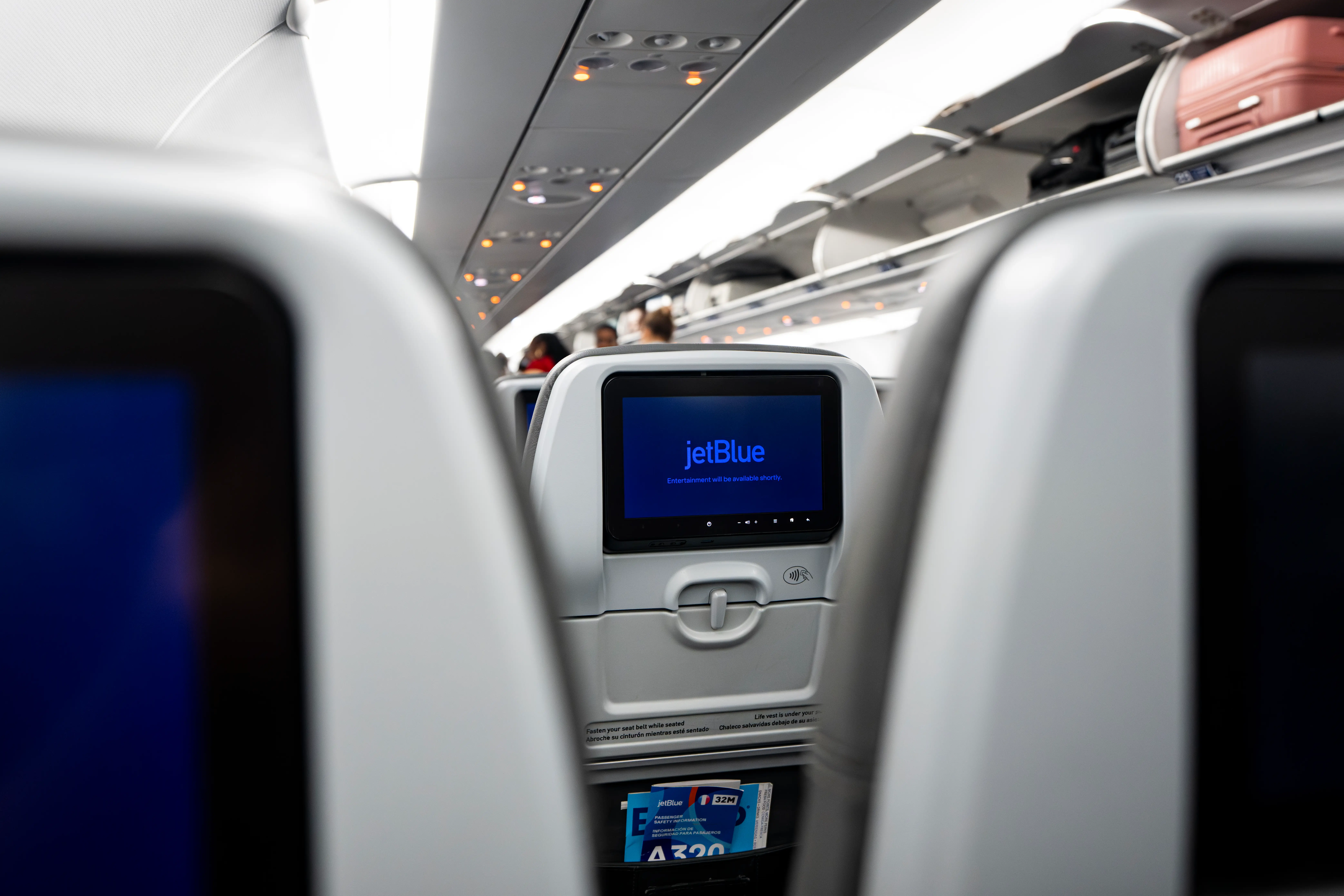 A digital screen on the back of a seat on a JetBlue Airbus A320.