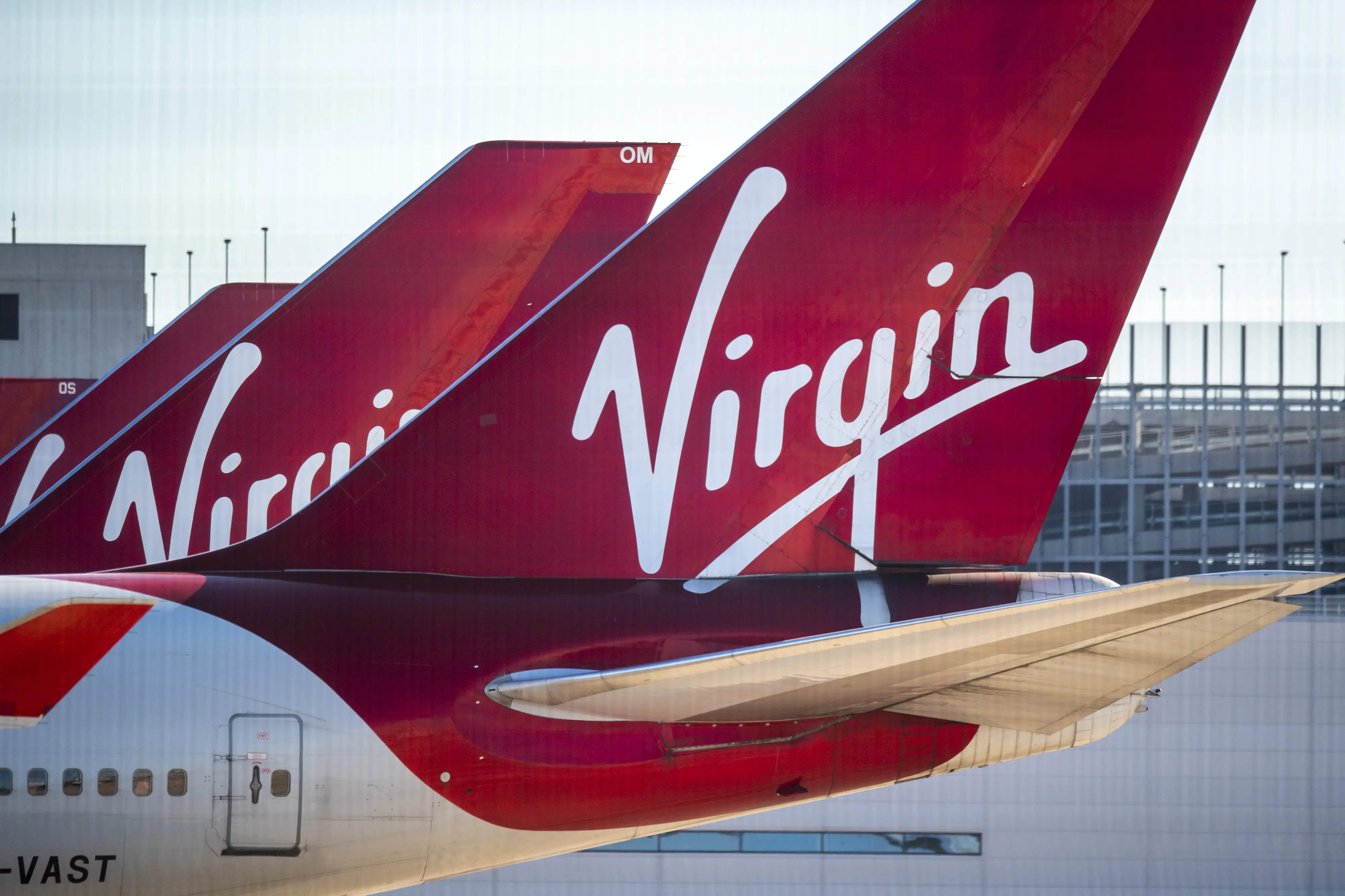 The Virgin logo sits on the tail-fins of passenger aircraft.