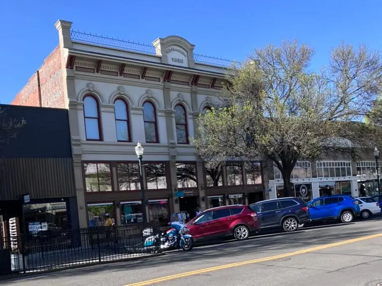 View of street with cars parked alongside it