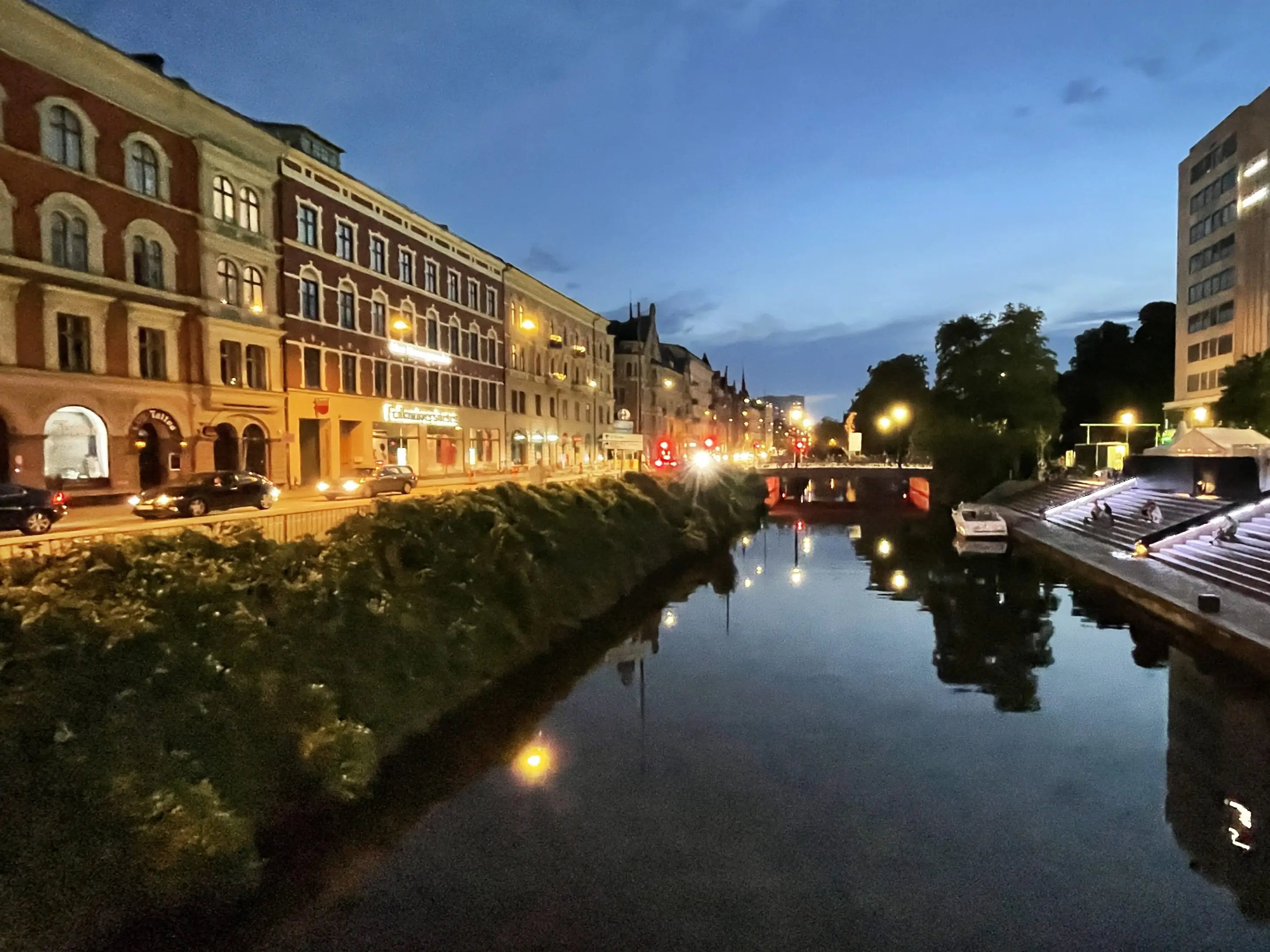 A river in a city at night.