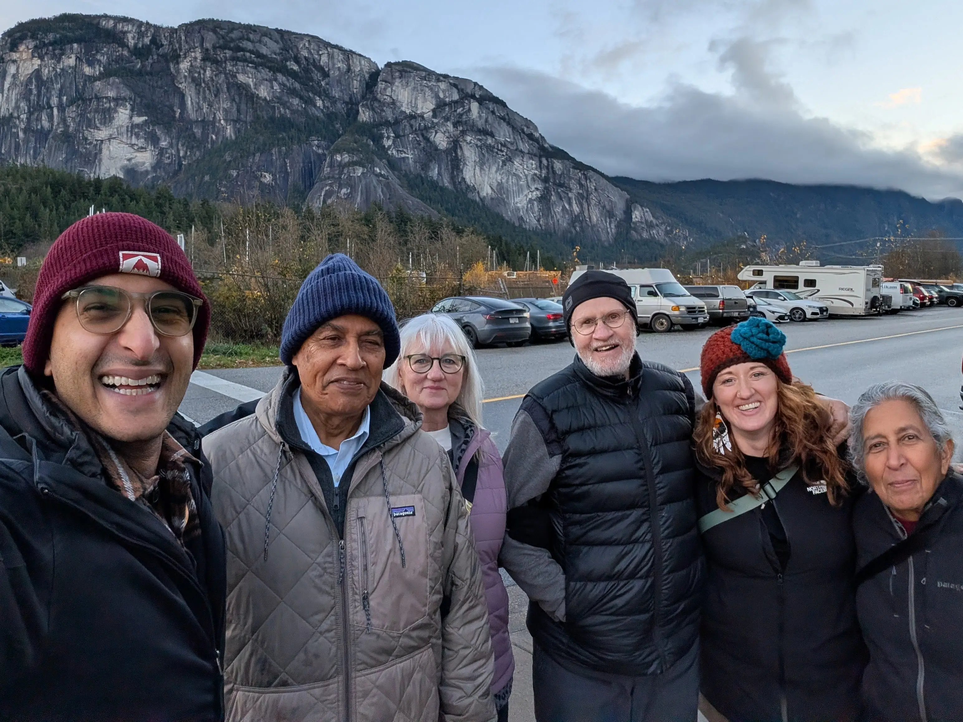 Woman smiling with partner and parents in Canada