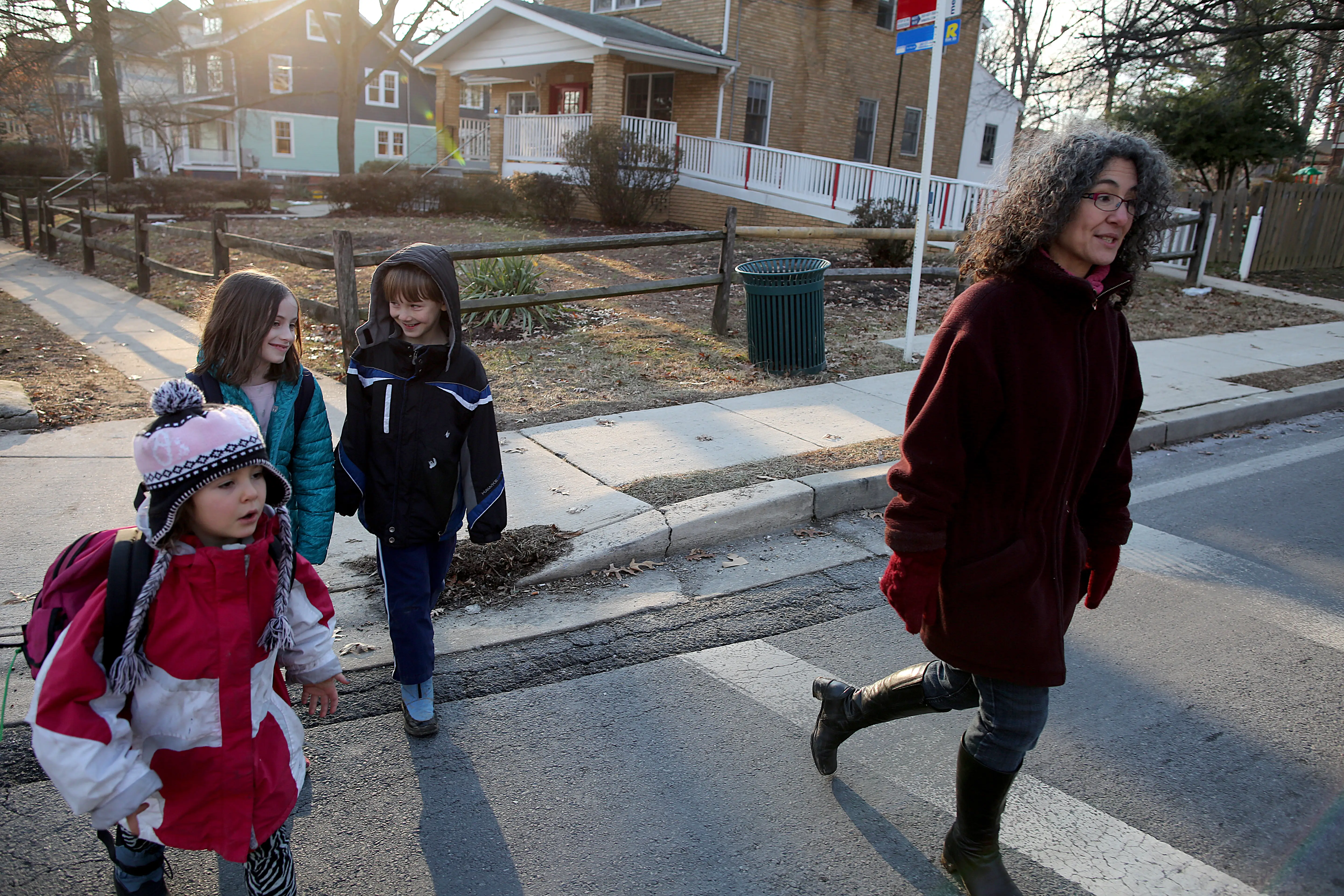 SILVER SPRING, MARYLAND - JANUARY 16: Danielle Meitiv, right, walks home with her daughter  Dvora Meitiv, 6, left, Rosie Resnick, 9, and her son Rafi Meitiv, 10, after being dropped off from school in Silver Spring MD, Friday January 16, 2015.