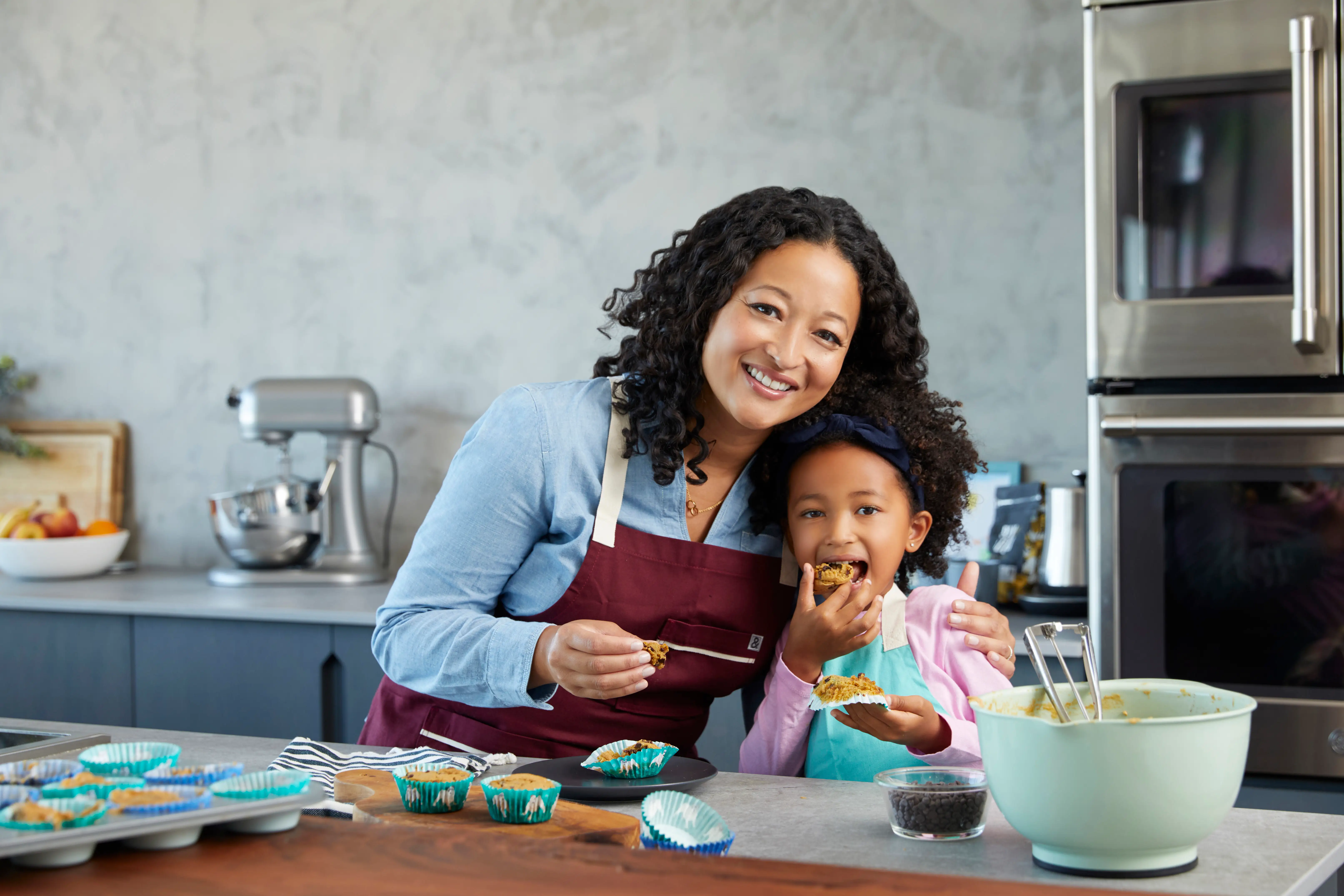 Denise Woodard with daughter baking in kitchen.