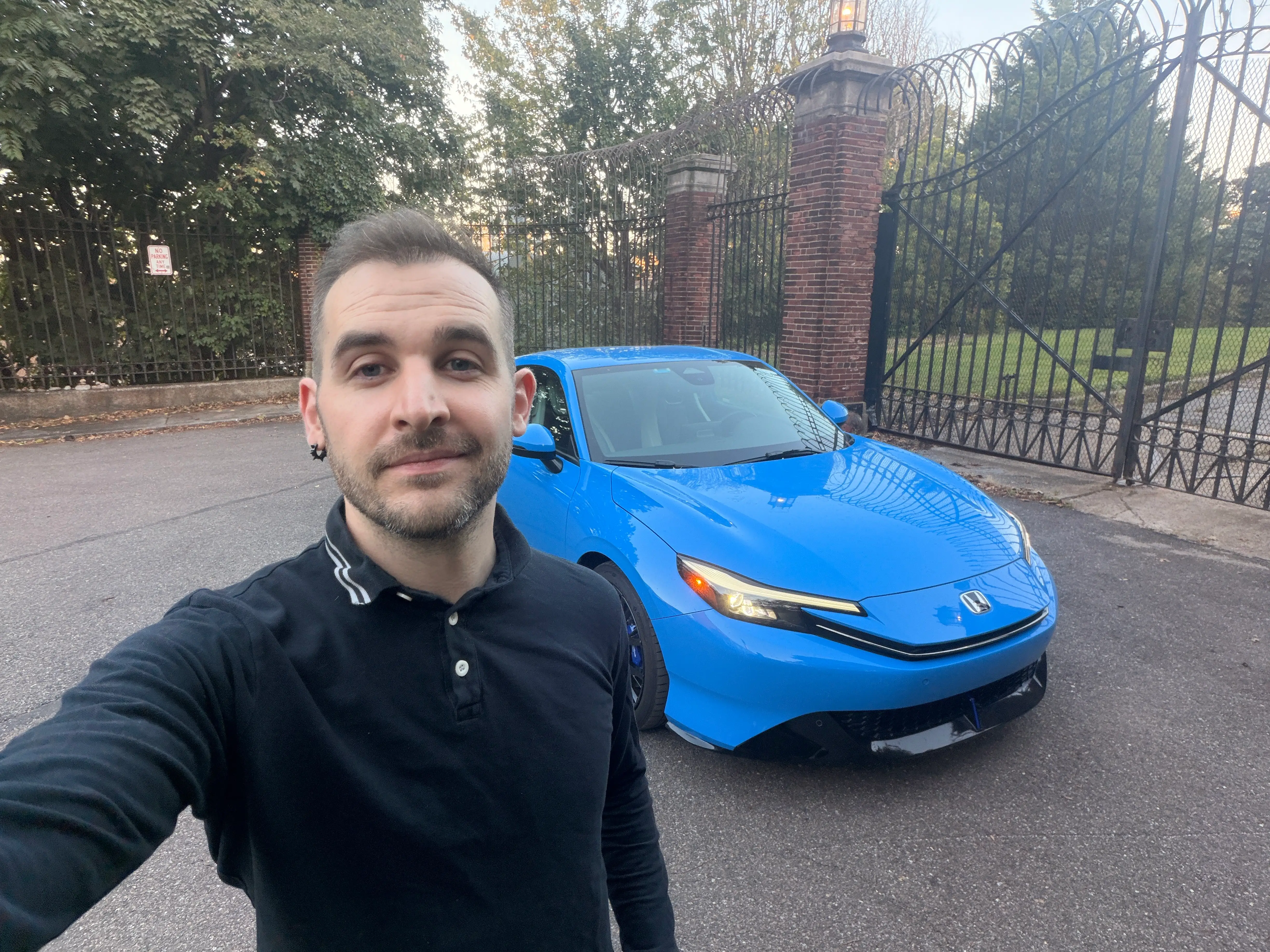 Business Insider's autos reporter, Ben Shimkus, is standing in front of a blue Honda Prelude.