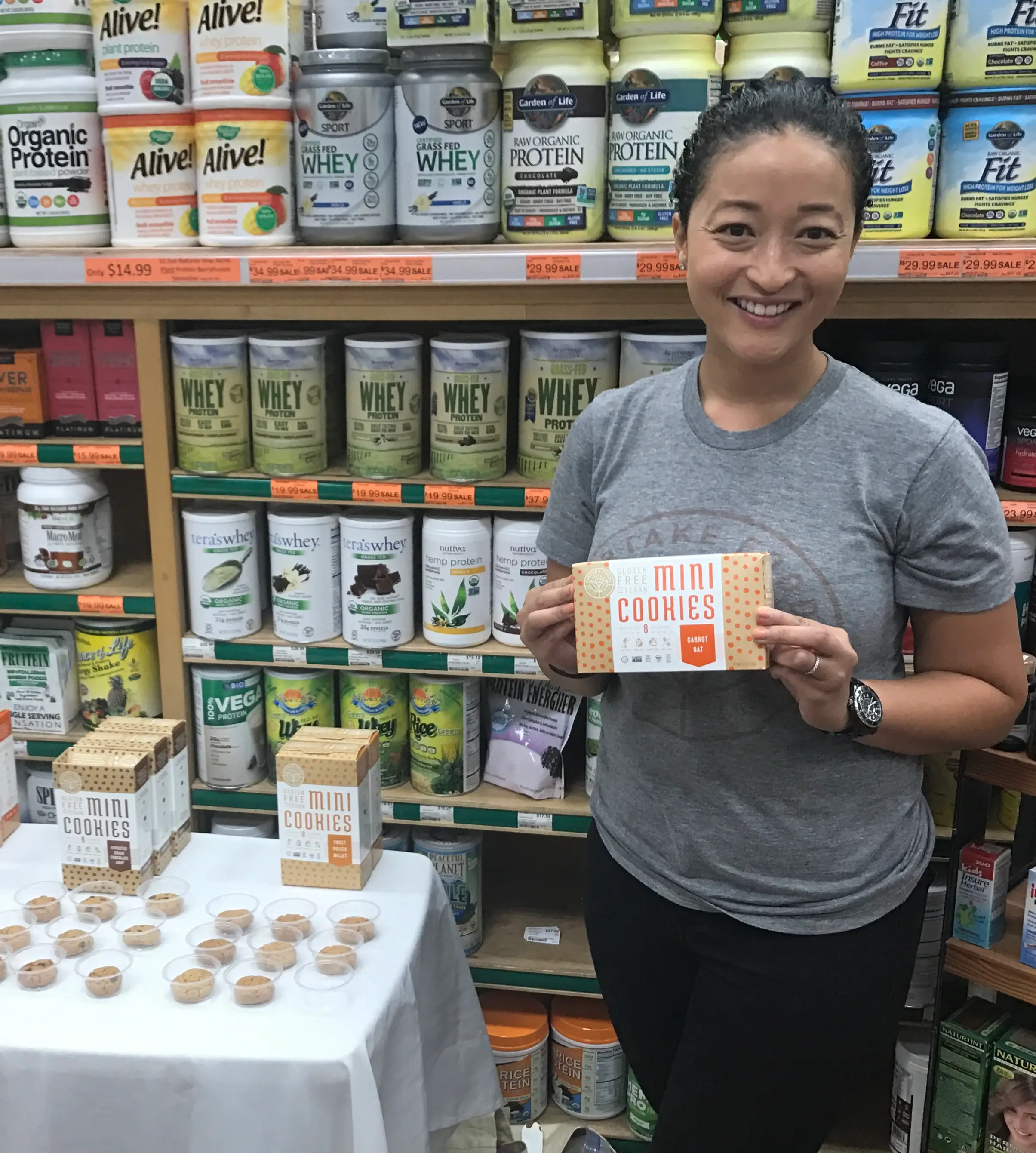 Denise Woodard, in the store with table samples of her mini cookies.