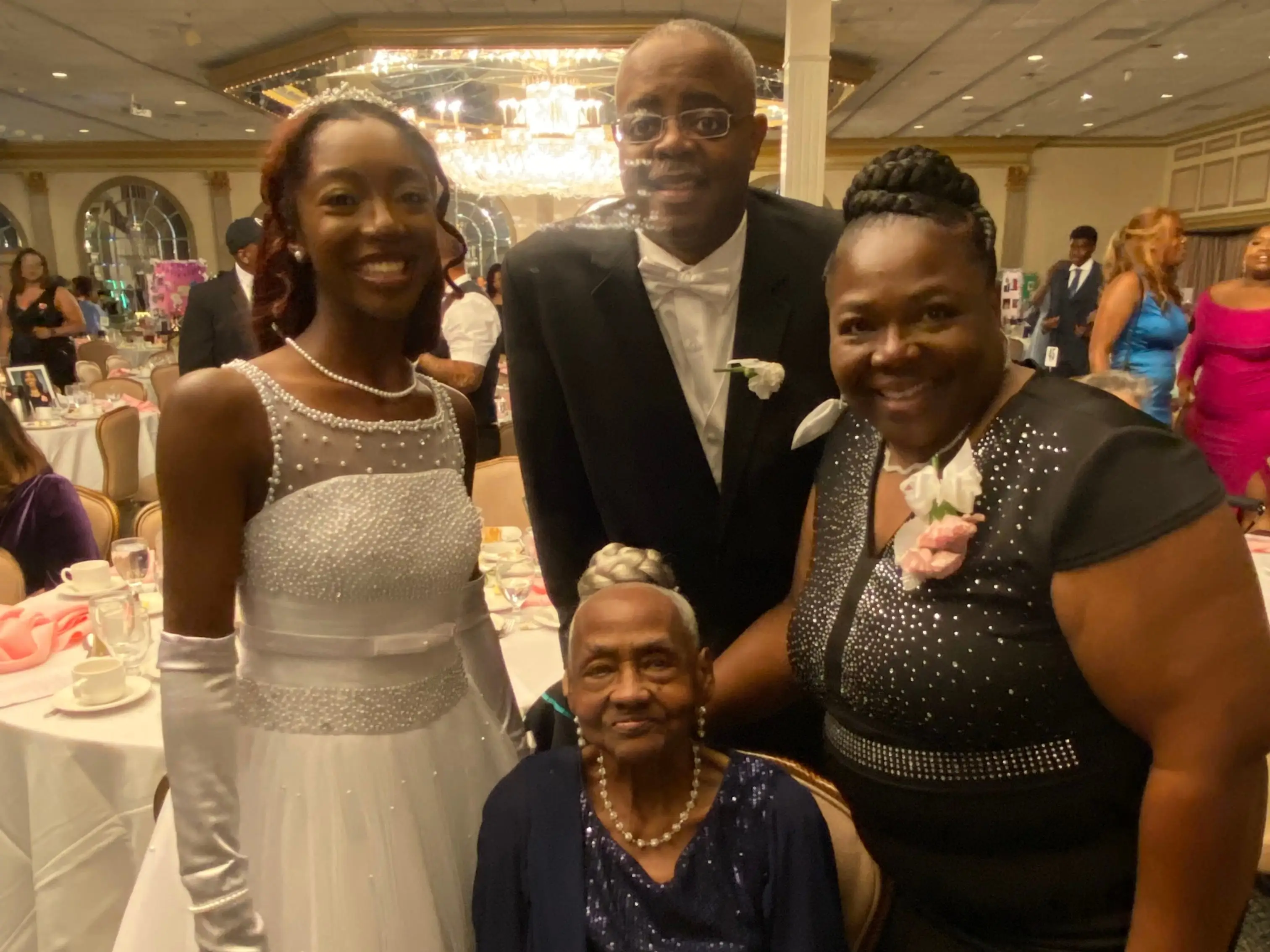 Four people at a wedding, including the bride.