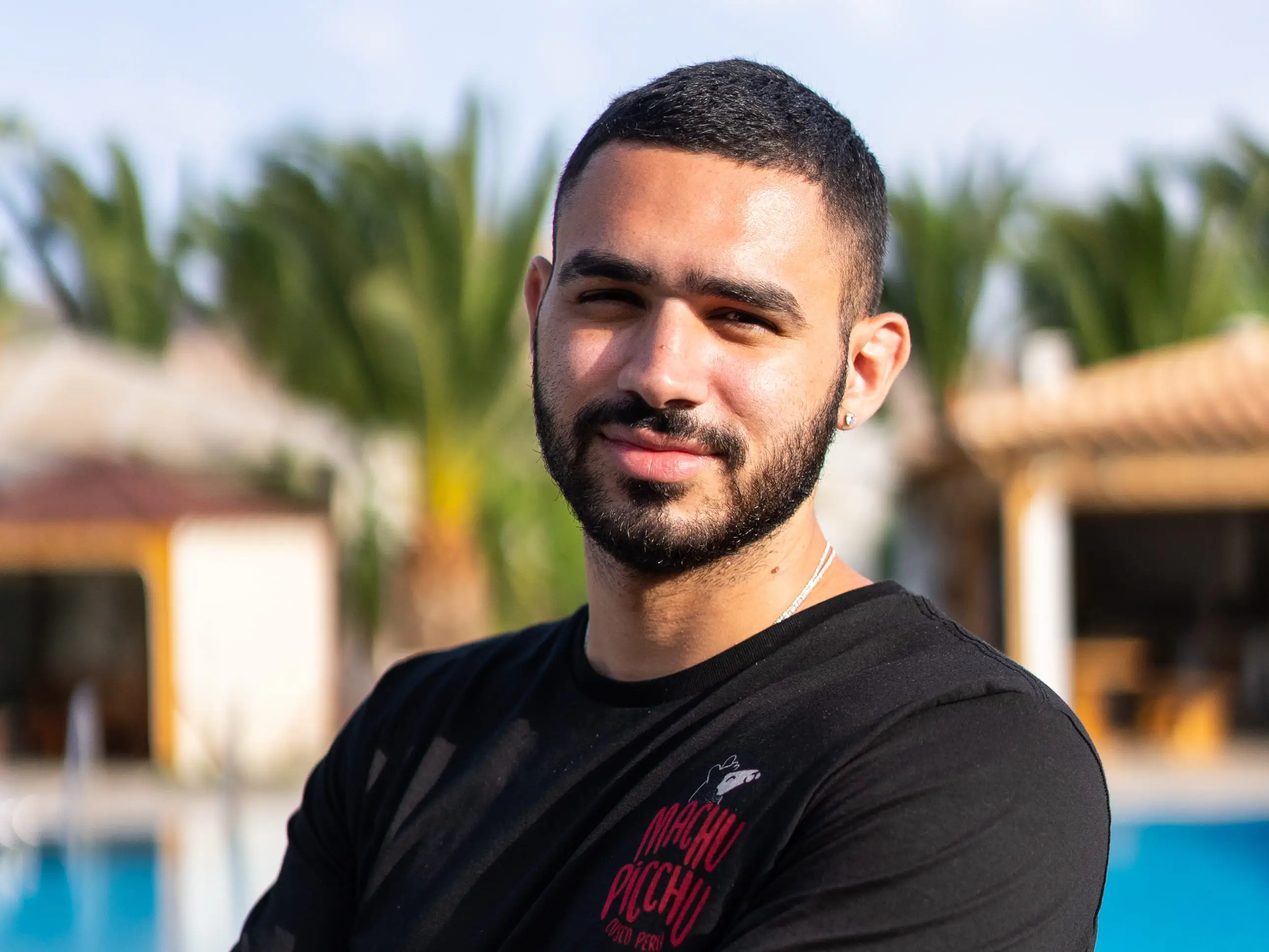 head shot of a man in front of a pool